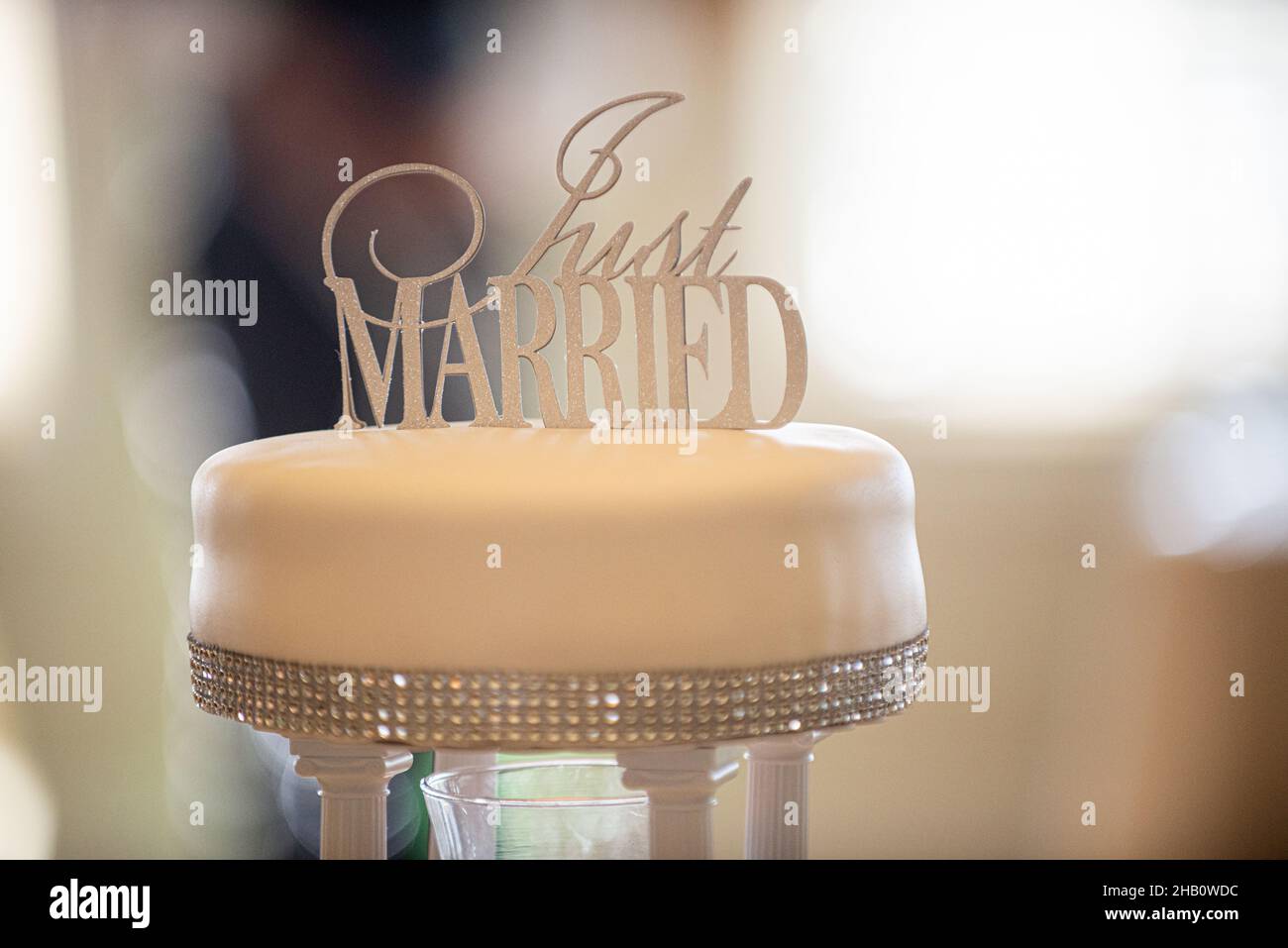 Wunderschöne einlagige Silberblende verzierte Hochzeitstorte mit Kuchenauflage, auf der steht „Just Married“ Stockfoto