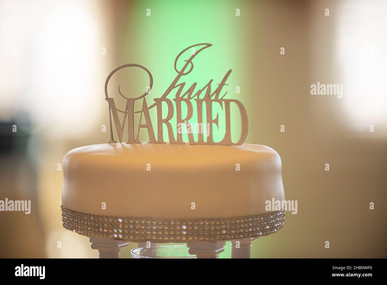 Wunderschöne einlagige Silberblende verzierte Hochzeitstorte mit Kuchenauflage, auf der steht „Just Married“ Stockfoto