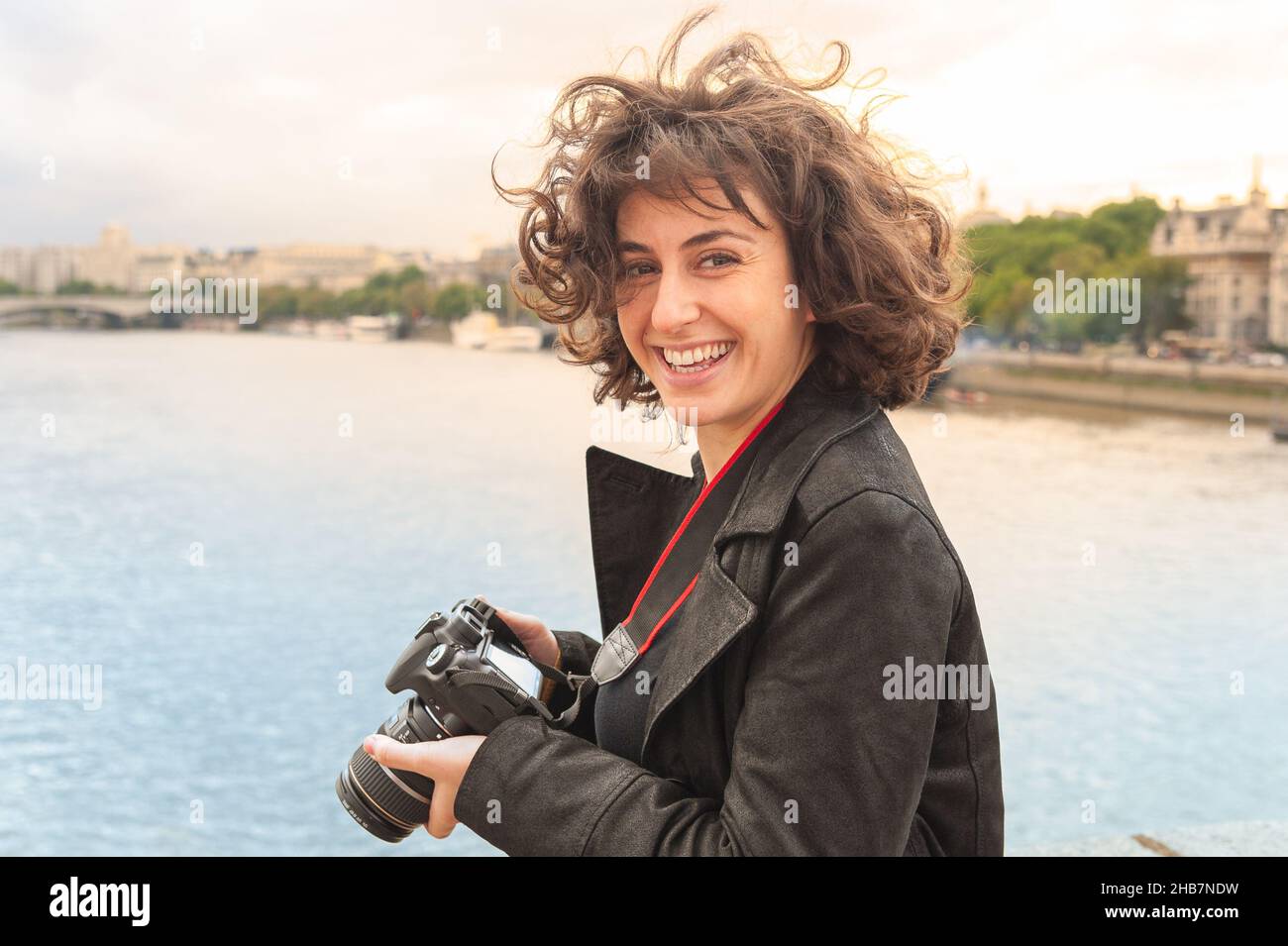 Attraktive, glückliche, junge, weibliche Touristen aus London fotografieren den Blick über die Themse auf einer Stadtrundfahrt Stockfoto