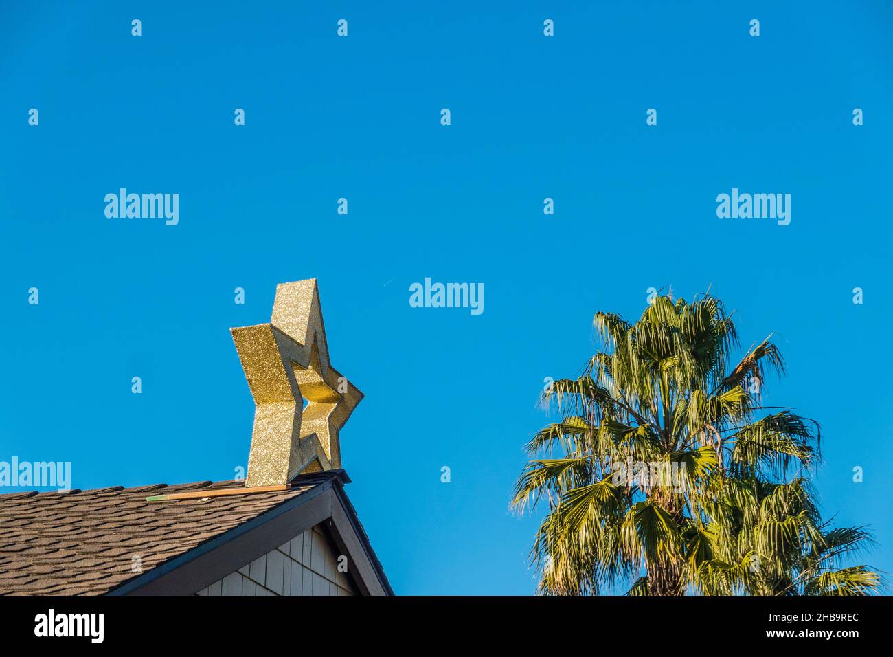 Ein goldener weihnachtsstern steht auf einem Dach des Hauses. Stockfoto