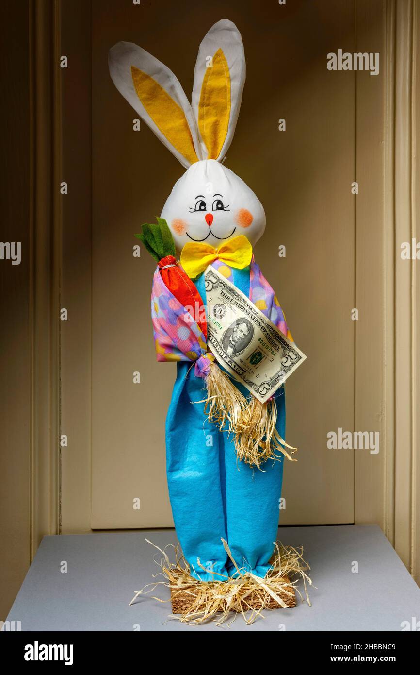 Gefülltes glückliches Kaninchen mit einer Banknote von fünf US-Dollar, Stockfoto
