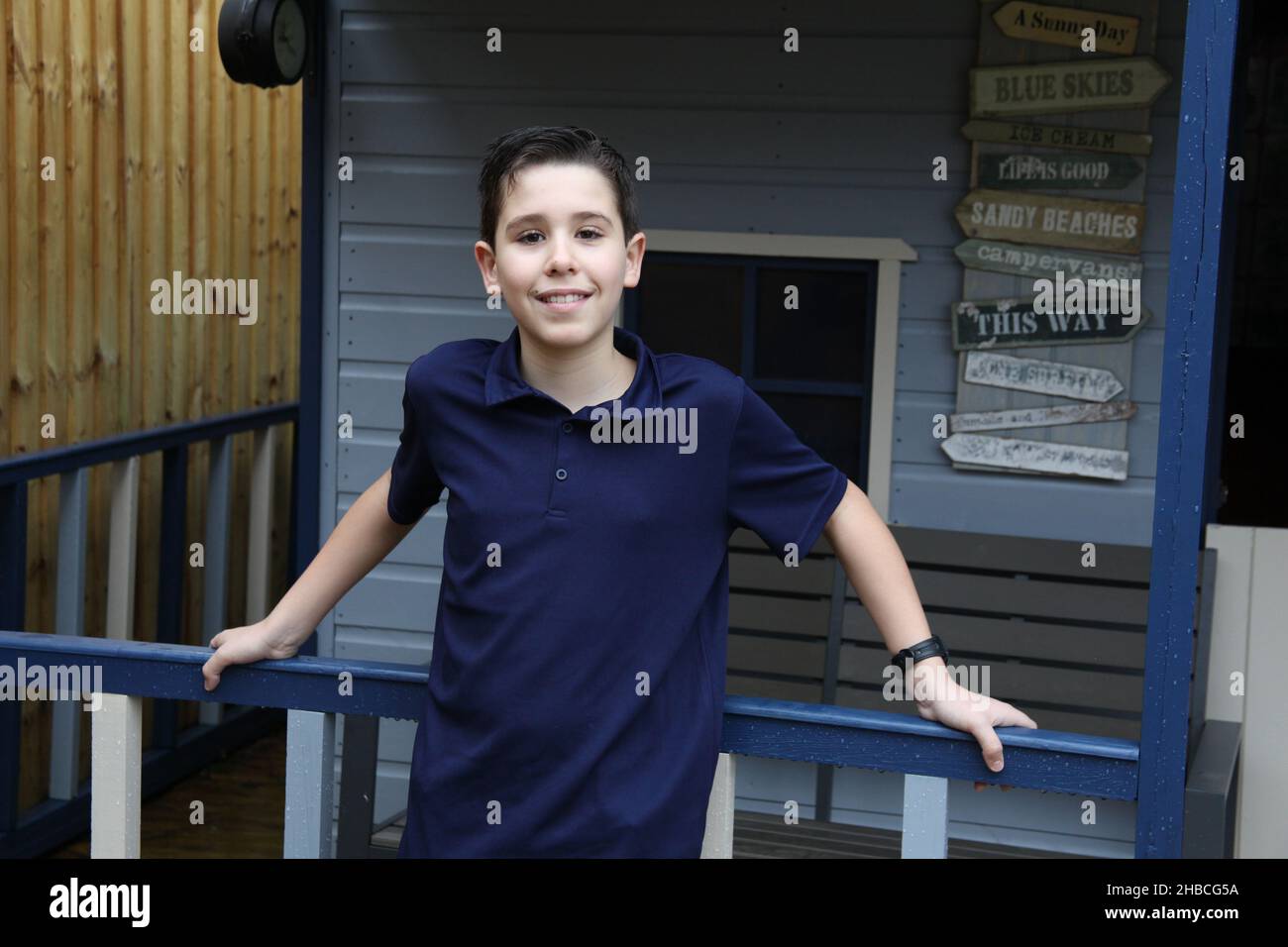 Ein Porträt eines zwölfjährigen Jungen in marineblau, beleuchtet von Umgebungslicht Stockfoto
