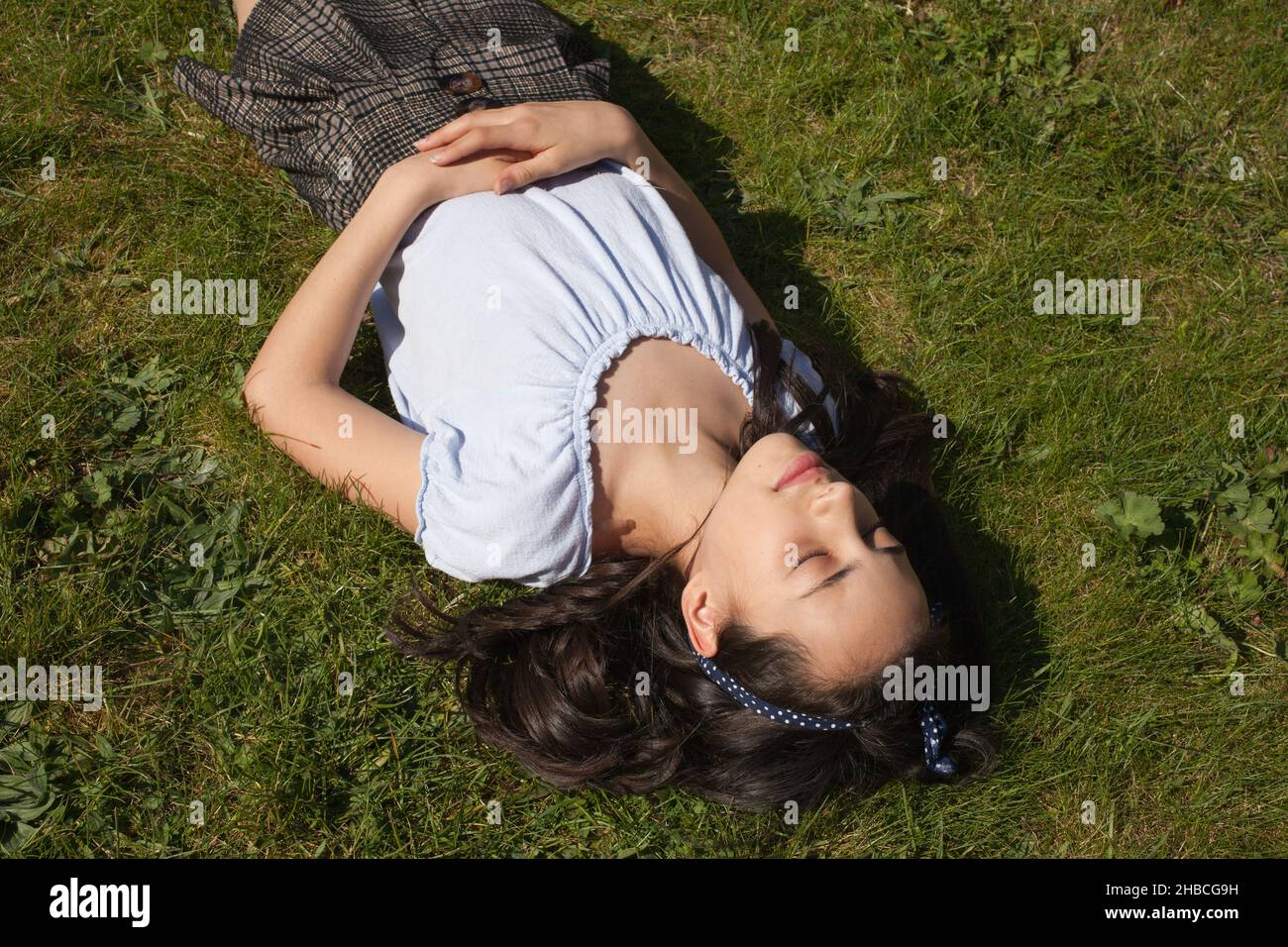 Ein Mädchen, das sich in ihrem Garten entspannt Stockfoto