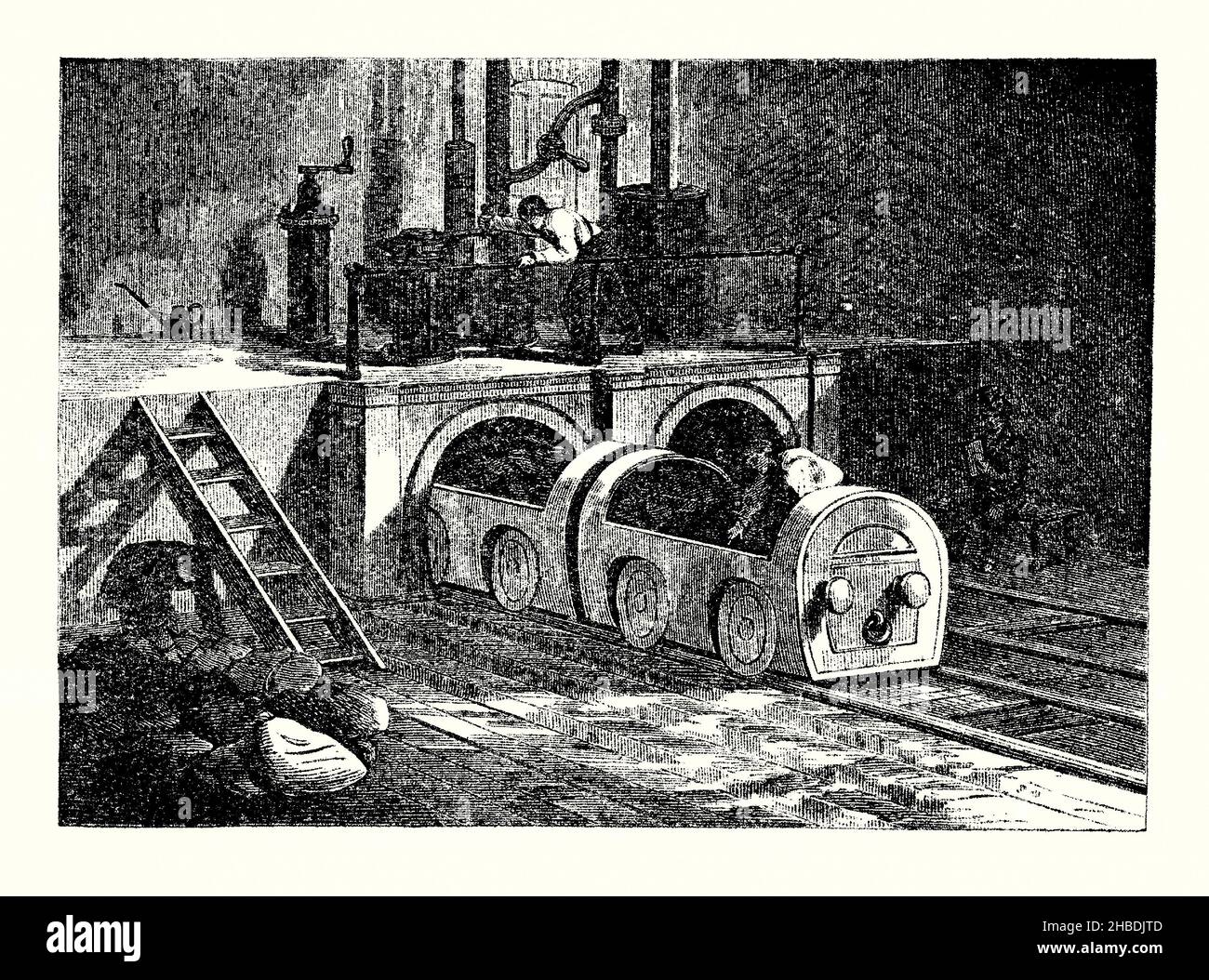 Eine alte Gravur der unterirdischen pneumatischen U-Bahn des Postamtes unter London, England, Großbritannien im Jahr 1860s. Es stammt aus einem Buch der 1890s über Entdeckungen und Erfindungen während der 1800s. Die London Pneumatic Dispatch Company (auch bekannt als London Pneumatic Dispatch Company) wurde 1859 gegründet, um eine U-Bahn-‘-Röhre’ mit Luftdruck und Vakuum für den Transport von Post, Paketen und leichter Fracht zu entwerfen, zu bauen und zu betreiben. Das System wurde zwischen 1863 und 1874 zwischen dem Bahnhof Euston und dem North West District Post Office in der Eversholt Street eingesetzt. Stockfoto