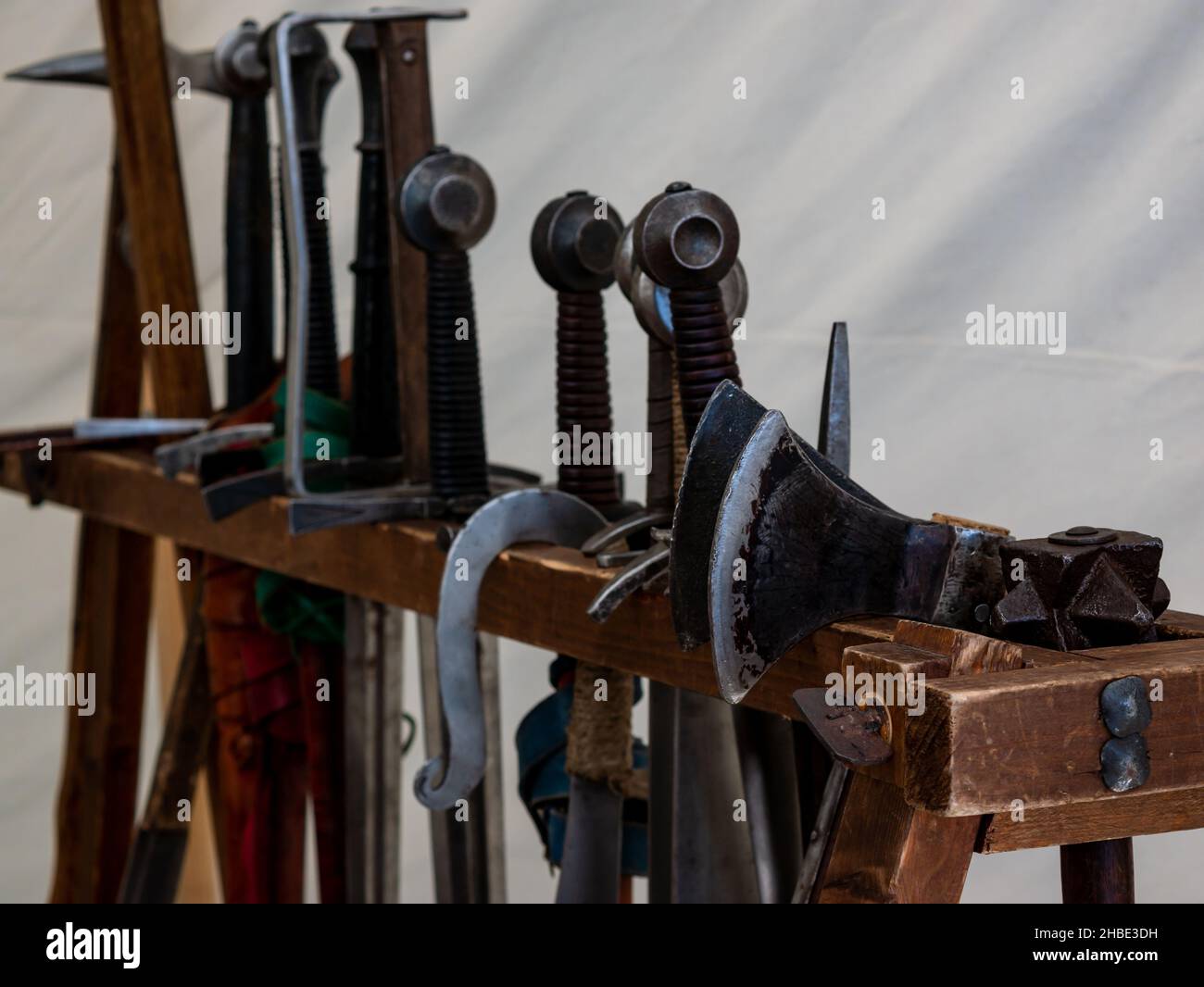 Verschiedene mittelalterliche Waffen auf einem Holzgestell Stockfoto