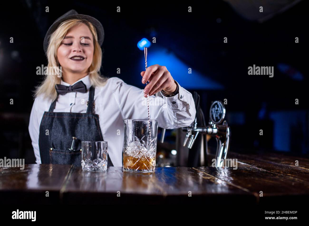 Die Barkeeperin kokt einen Cocktail in der Brasserie Stockfoto