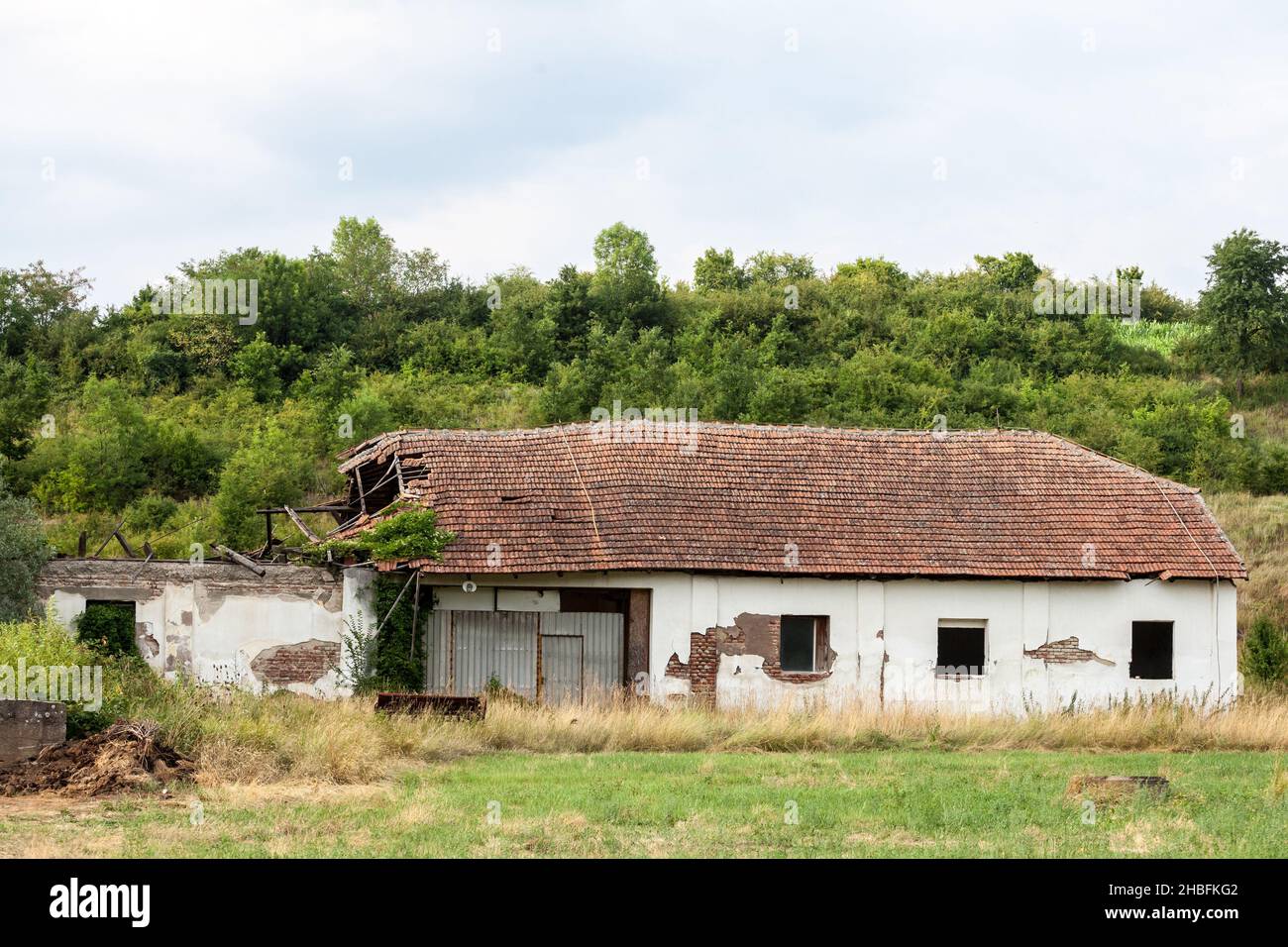 Bild eines verlassenen Bauernhofes in Zentralserbien, dessen Fassade zum Zerbröckeln verurteilt wurde. Stockfoto