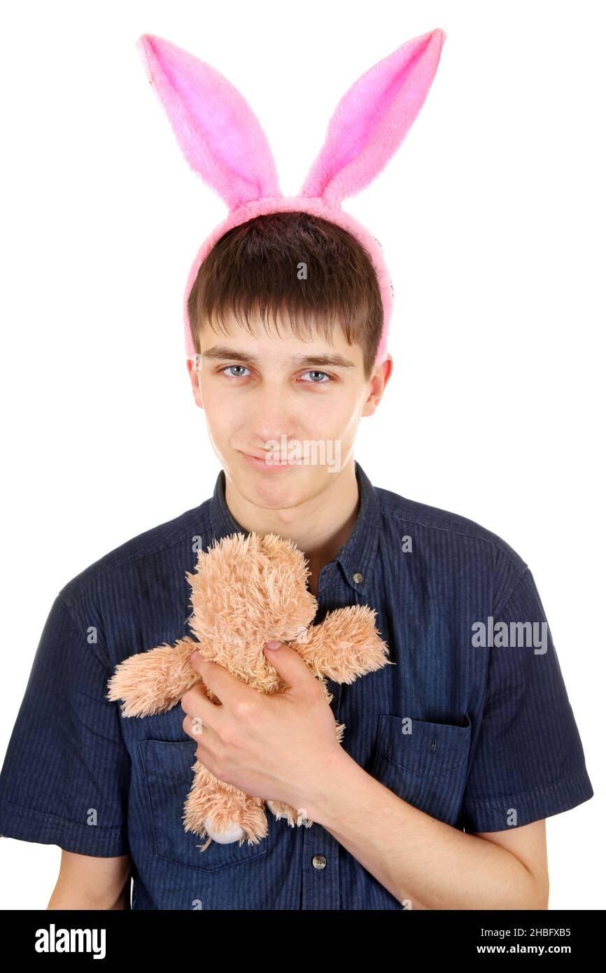 Kindliche Teenager mit Hasenohren und Teddybär isoliert auf dem weißen Hintergrund Stockfoto