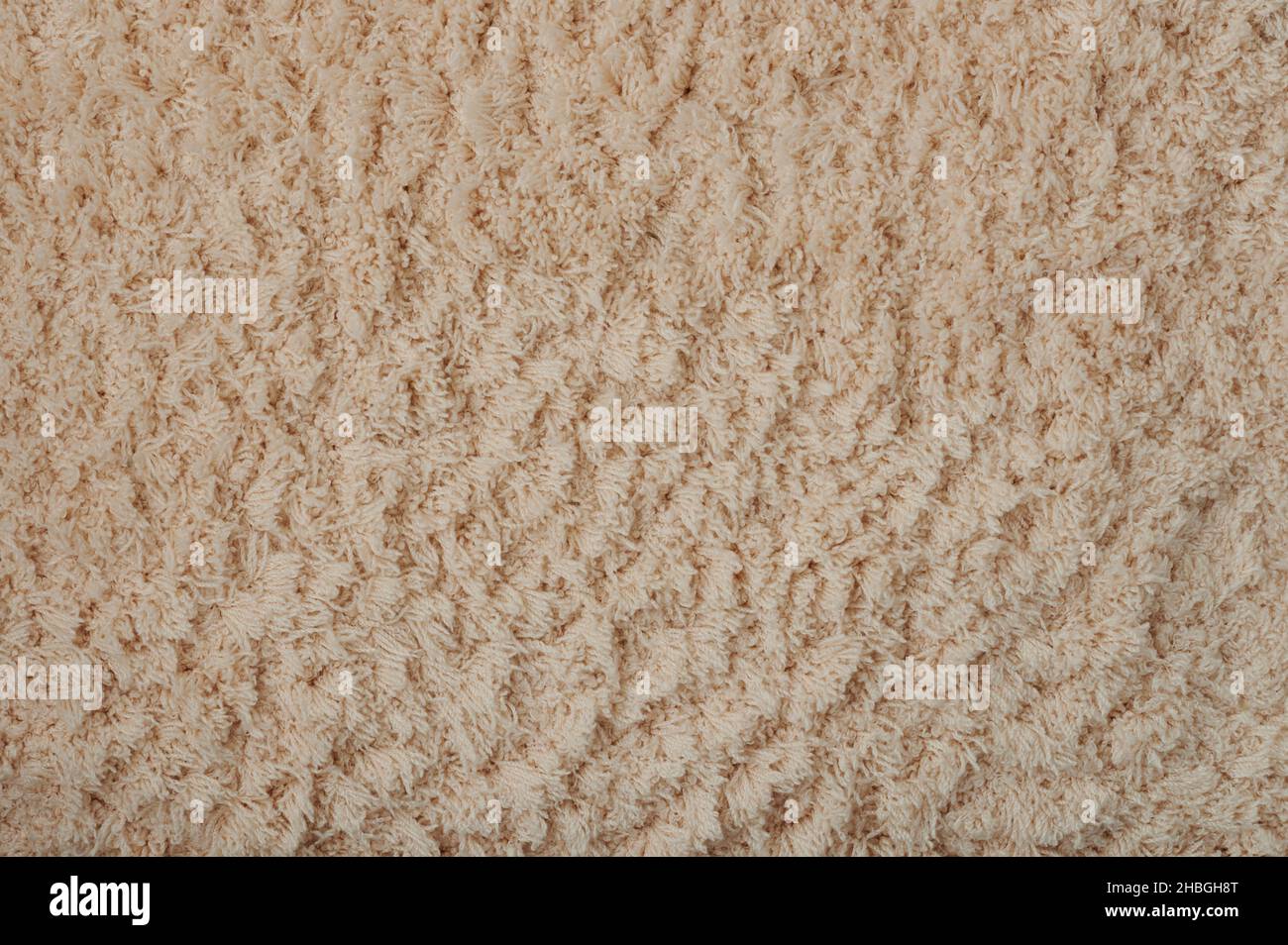 Textur von braunen weichen flauschigen Teppich Makro Nahaufnahme Stockfoto