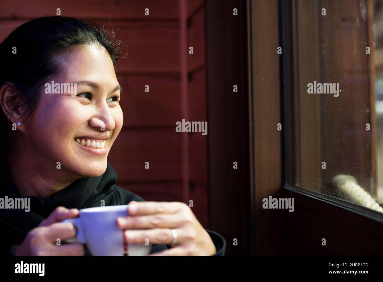 Frau genießt ein heißes Getränk im Café in Frankreich Stockfoto