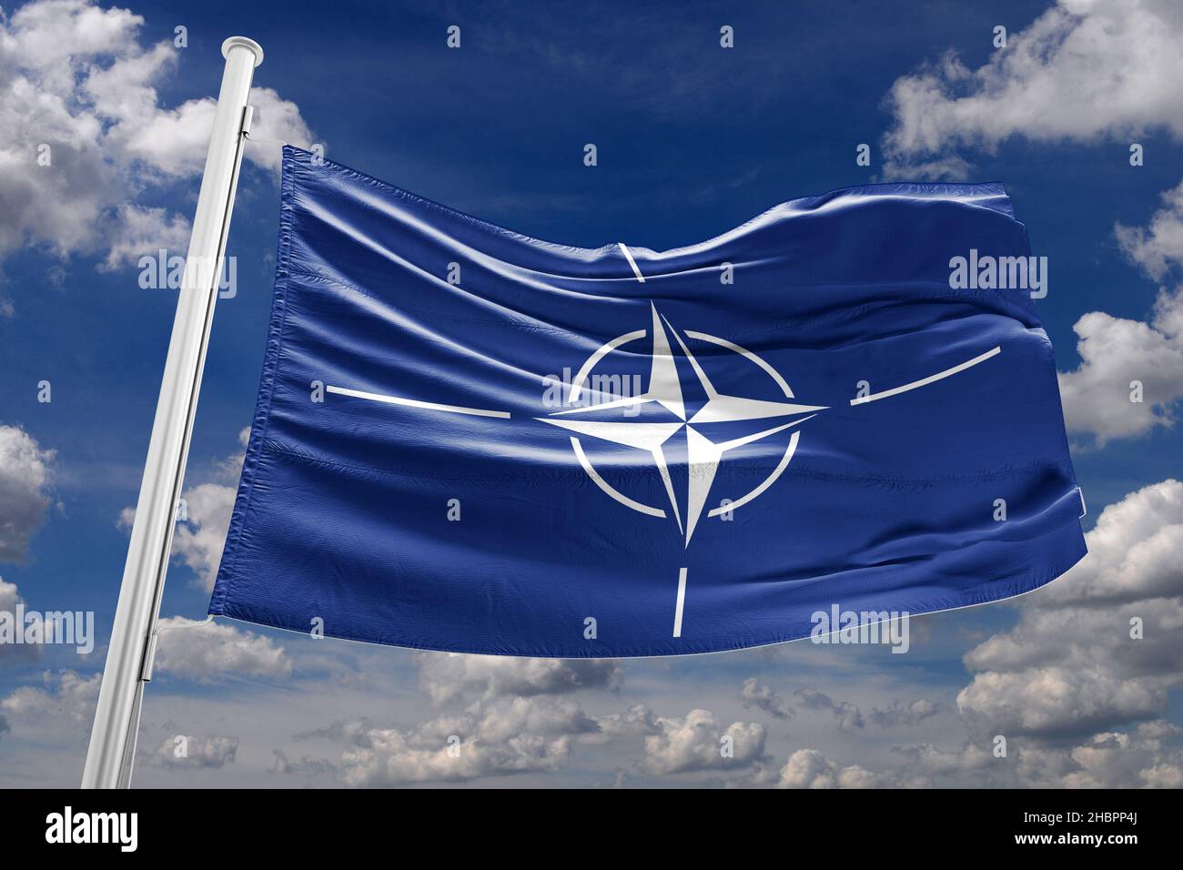 NATO-Flagge winkt vom Wind Stockfoto