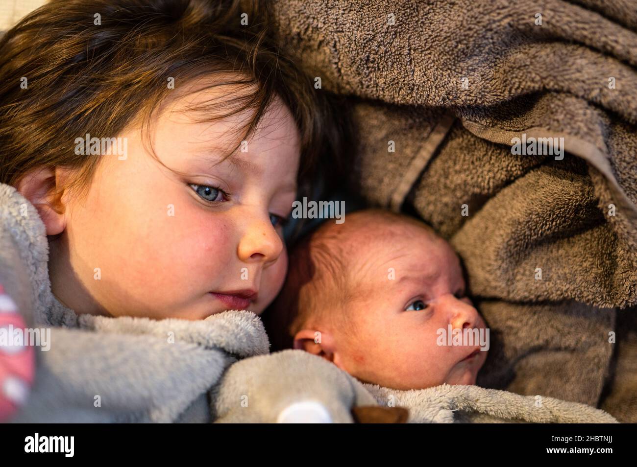 Ein junges Mädchen und ihr neugeborener Bruder. Stockfoto