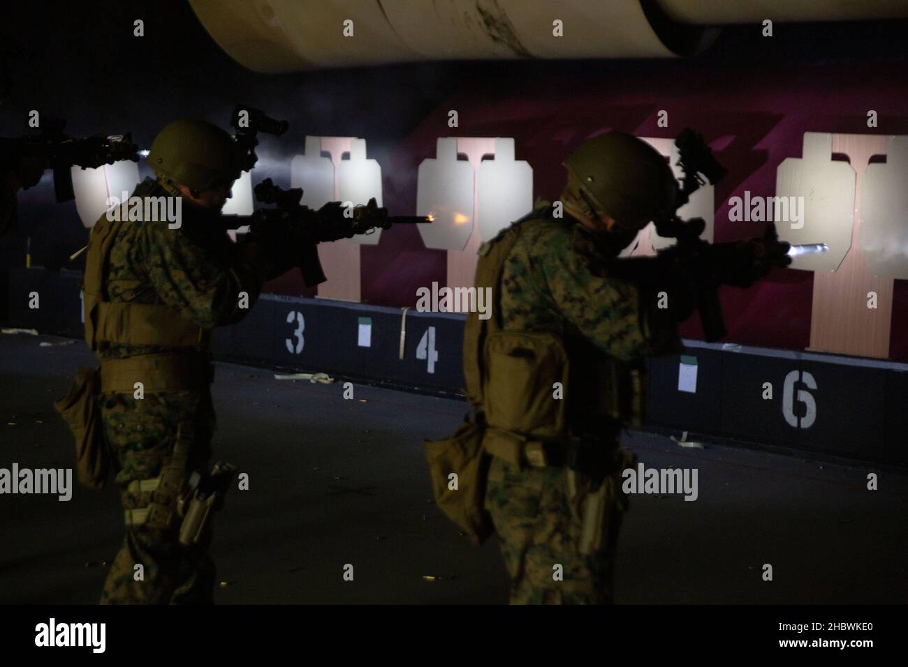 US Marine Corps Staff Sgt. Sean J. Boyd, links, ein Ausbilder der Sicherheitskräfte und Staff Sgt. Dallas Bush, rechts, ein Instruktor für Nahkampf (CQB), beide Schützen mit dem Marine Corps Security Force Regiment, führen während der Übung Tartan Eagle Phase II, Northumbria Police Range, Wallsend, England, 12. Dezember, Waffen- und Pistoleneingriffsübungen durch. 2021. Der Bereich erlaubte es den britischen Royal Marine CQB-Instruktoren, den US-Marineinfanteristen verschiedene Schießtechniken vorzustellen und ihre Fähigkeiten im feindlichem Einsatz bei begrenzter Beleuchtung zu testen. Übung Tartan Eagle ist eine bilaterale biye Stockfoto