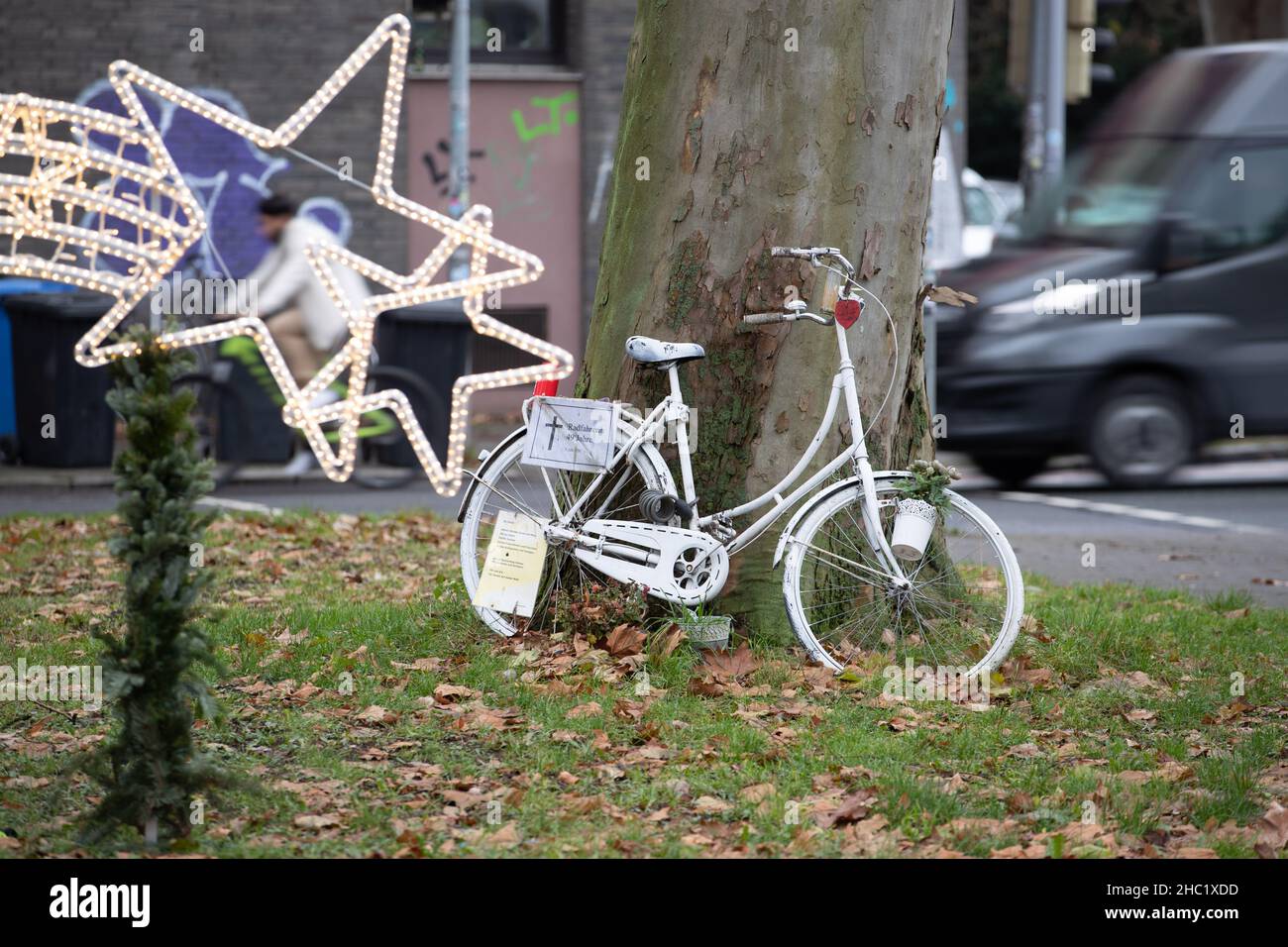 17. Dezember 2021, Niedersachsen, Osnabrück: Ein sogenanntes "Geisterrad" steht als Mahnmal auf einer belebten Stadtstraße. Mehrere komplett weiß lackierte Fahrräder stehen an Orten, an denen Radfahrer tödliche Unfälle hatten. Foto: Friso Gentsch/dpa Stockfoto