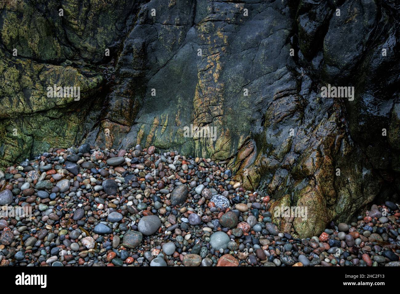 Farbenfrohe Felsen und Kieselsteine auf der Isle of Iona. Stockfoto