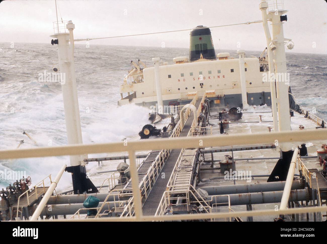 S.S. Texaco Brisbane auf See, bei rauem Wetter nach hinten schauend. Diejenigen von uns, die in der Vorwärtsunterkunft lebten (Kapitän, Deckoffiziere und Funker) mussten den Laufsteg hinunter zu der anderen Unterkunft (gezeigt) für unsere Mahlzeiten gehen. Das Schiff wurde 1960 gebaut und 1977 verschrottet. Foto aus dem Jahr 1972. Stockfoto