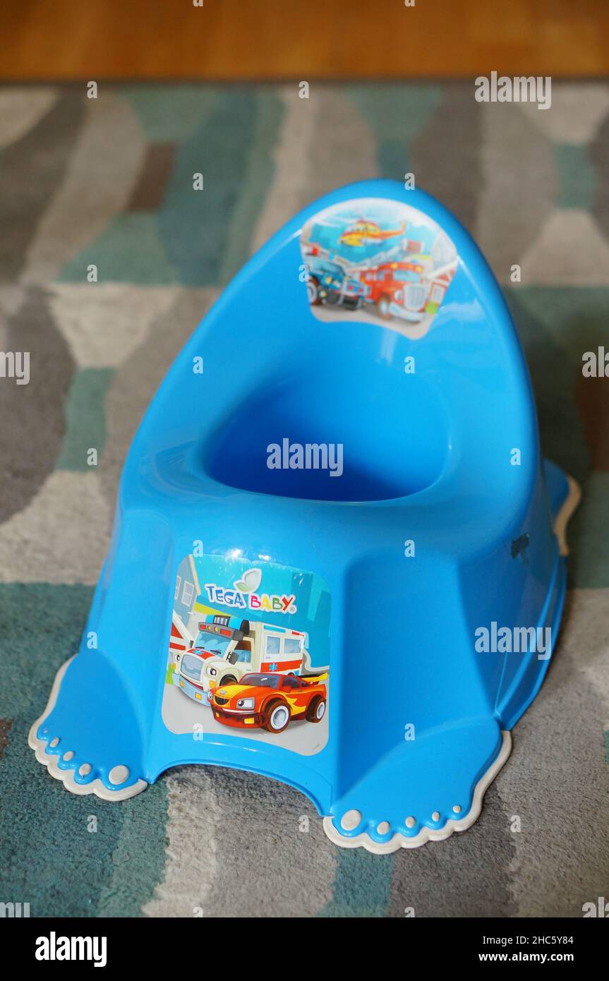 Blaues Plastikköpfchen für Kinder auf Teppichboden Stockfoto