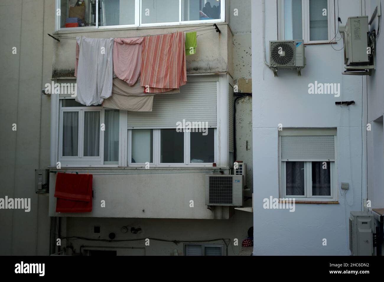 Vertikale Aufnahme eines Gebäudes mit Kleidung vor Glasfenstern Stockfoto