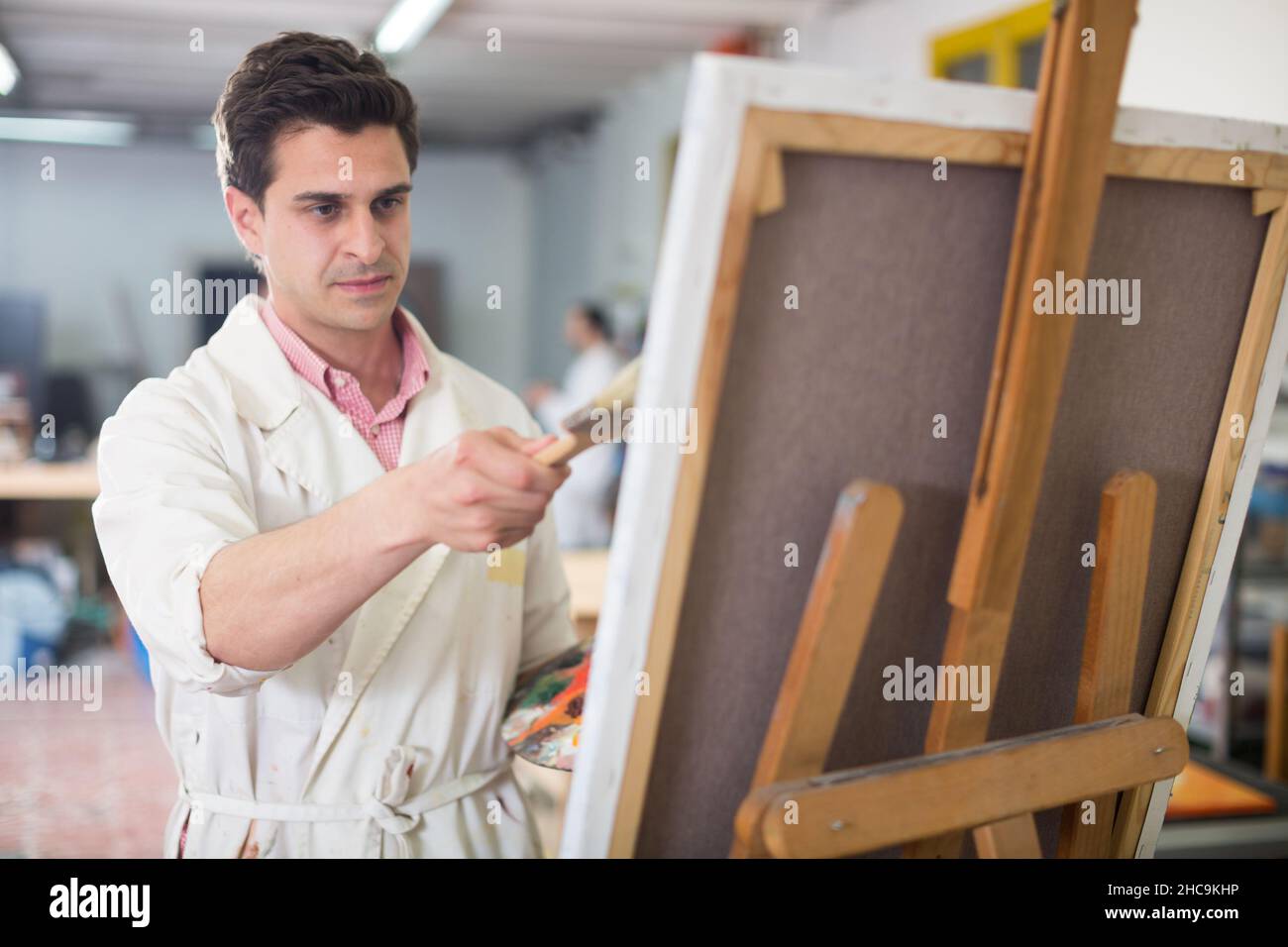 Mann in der Nähe Staffelei Malerei auf Leinwand Stockfoto