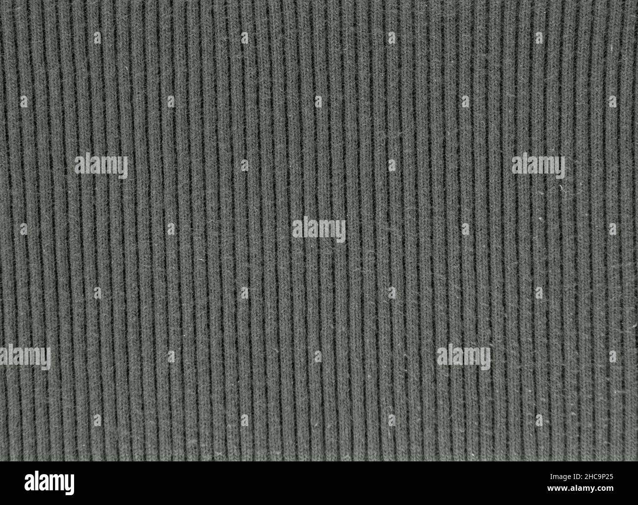 Dunkelgrüne Feinripp-Strickkleidung aus Baumwolle bei kaltem Wetter Stoffmuster Stockfoto