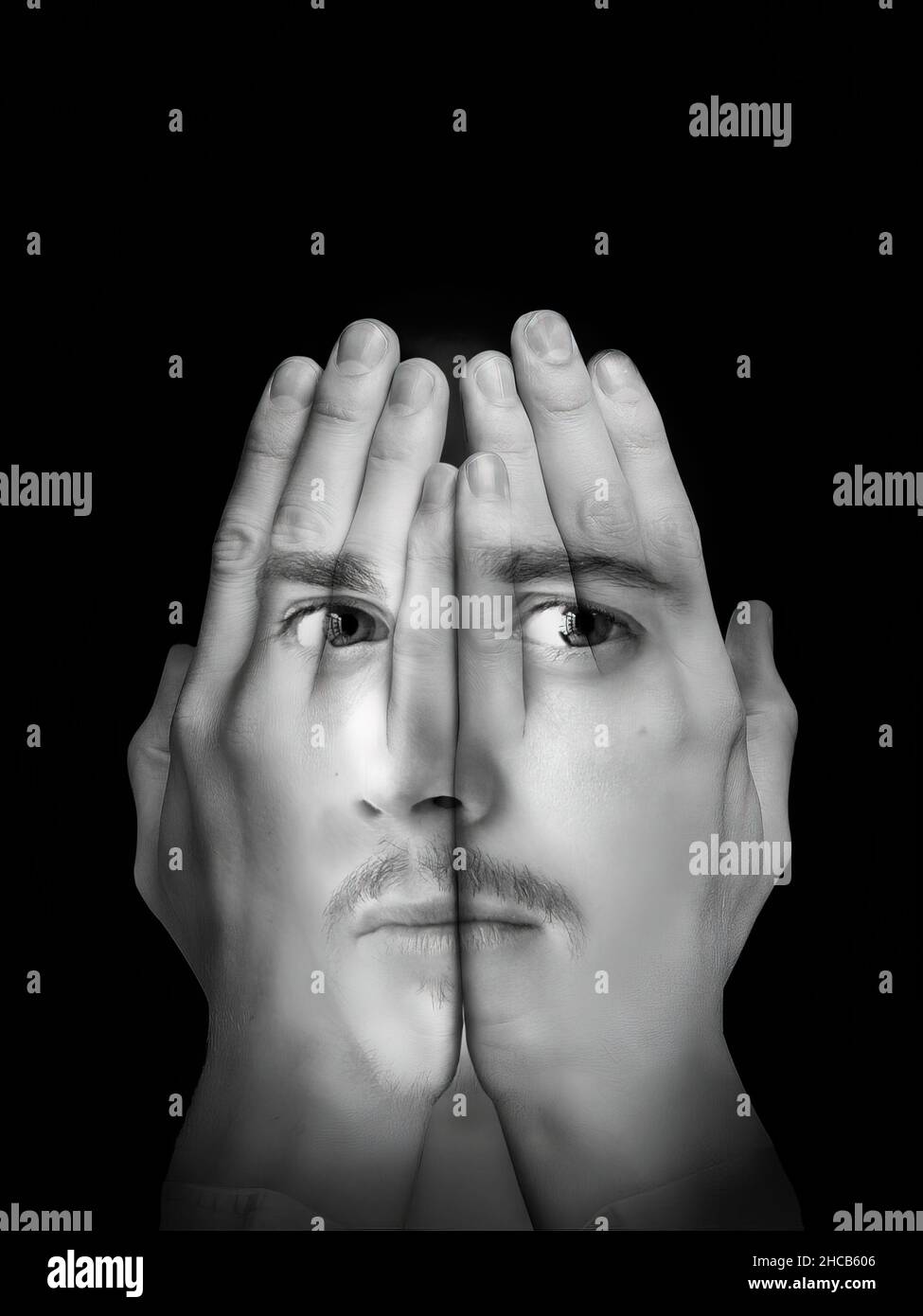 Fotomontage des Gesichts eines hübschen jungen Mannes mit einem Schnurrbart auf einem Paar ausgestreckter Hände. Schwarzweiß-Fotografie. Stockfoto