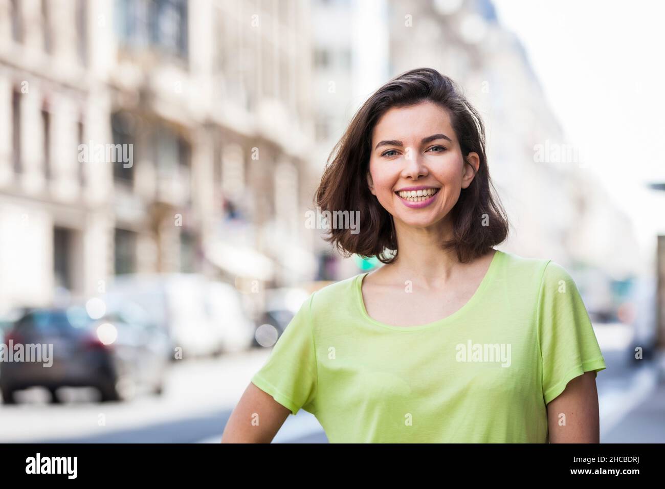 Glückliche schöne Frau mit kurzen Haaren in der Stadt Stockfoto