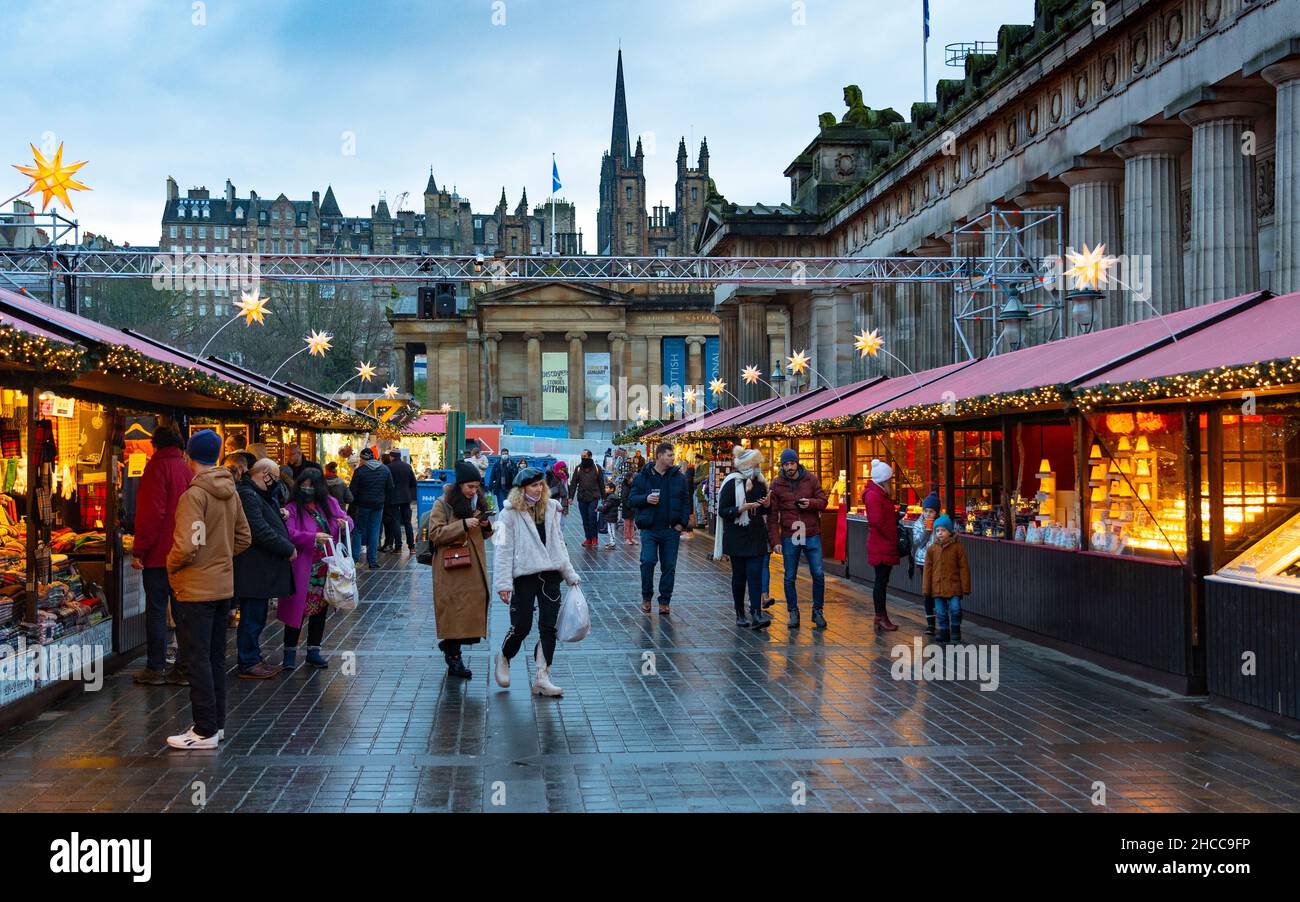 Edinburgh, Schottland, Großbritannien. 27th. Dezember 2021. Der Weihnachtsmarkt in Edinburgh wurde am zweiten Weihnachtsfeiertag mit neuen Regeln wiedereröffnet, um die Verbreitung der Omicron-Variante von Covid-19 zu verhindern, insbesondere wird nur ein Eingang verwendet, um die Anzahl zu heben. Besucher werden gebeten, vor dem Besuch einen seitlichen Durchflusstest durchzuführen. Tragen Sie eine Maske, halten Sie sich etwa 2m auseinander und folgen Sie den Schildern in den Gärten der East Princes Street. Abb. Die Besucherzahlen werden nach den neuen Vorschriften reduziert. Iain Masterton/Alamy Live News. Stockfoto