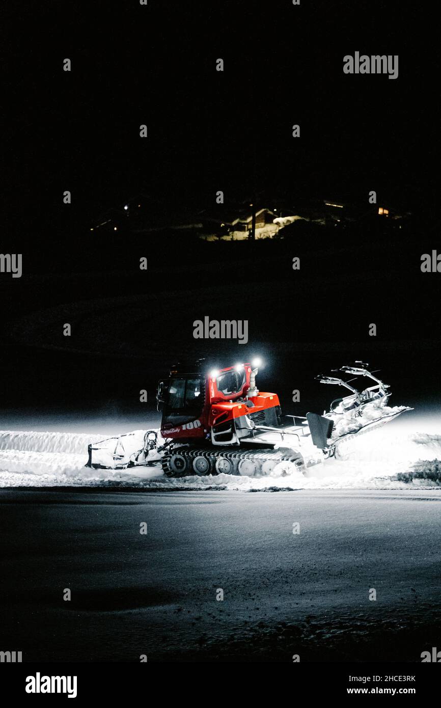 Vertikale Aufnahme einer Industriemaschine, die Schnee auf einem Feld bewegt Stockfoto