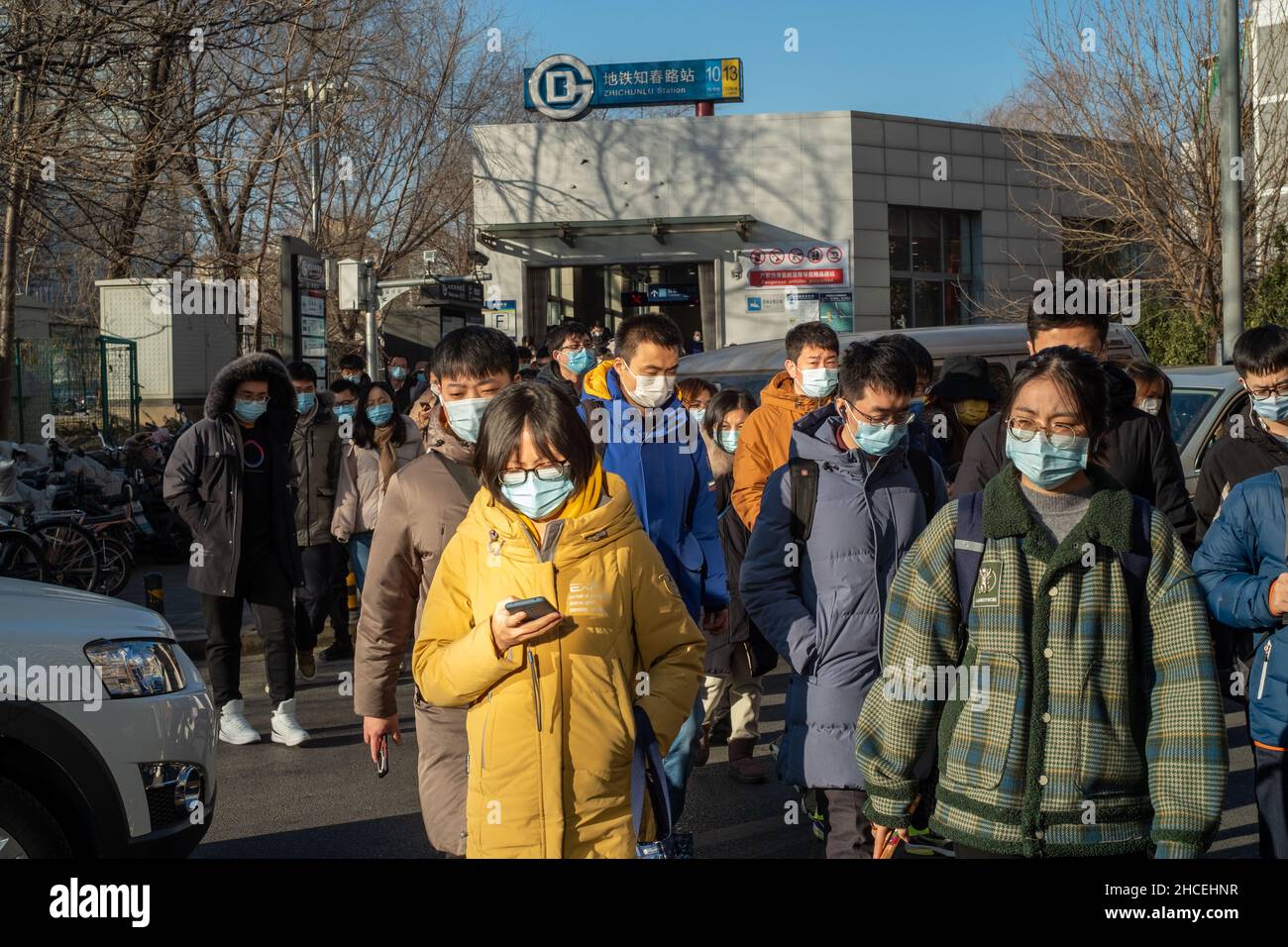 Pendler am Morgen gehen aus einem U-Bahn-Ausgang in Zhongguancun, dem Technologiezentrum in Peking, China. 27-Dez-2021 Stockfoto