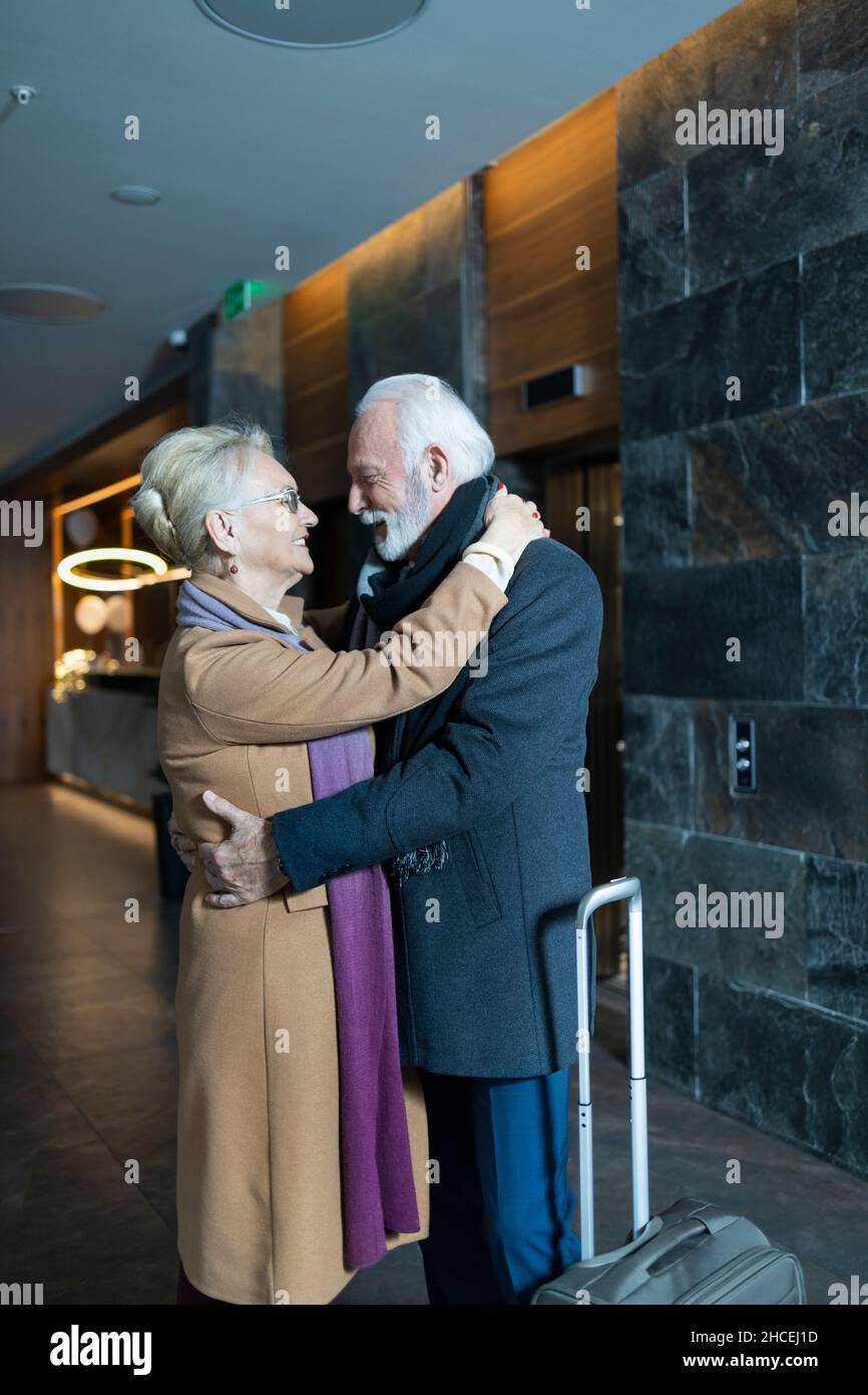 Ältere Frau und Mann umarmen sich in einem Hotel Stockfoto