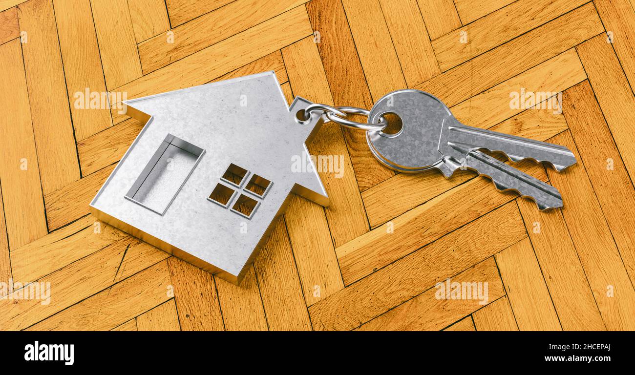 Haus als Anhänger auf einem Schlüssel auf Holzboden als Hauskauf- und Wohnkonzept Stockfoto