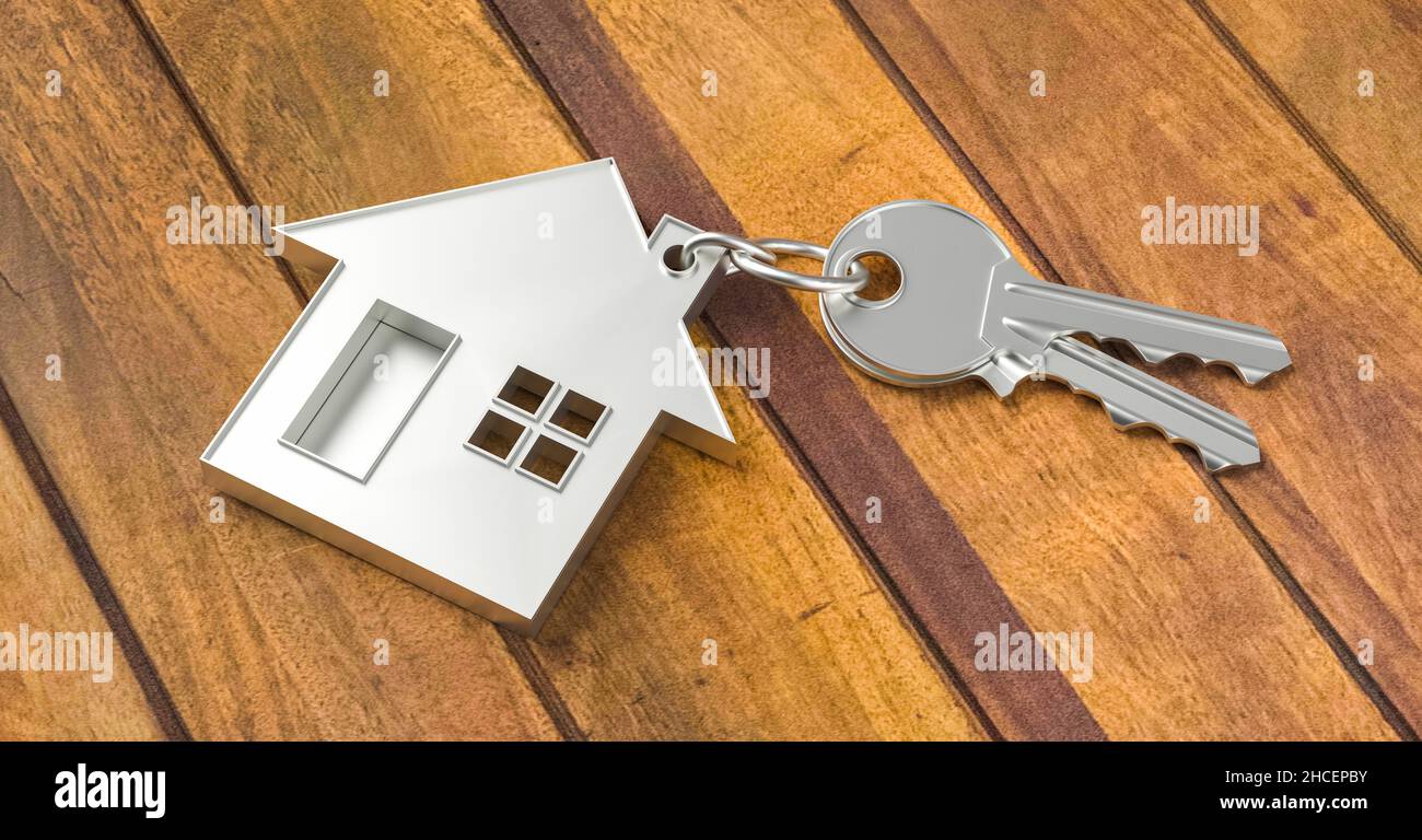 Kauf eines Hauses mit zwei Hausschlüsseln auf einem Holzboden Hintergrund Stockfoto