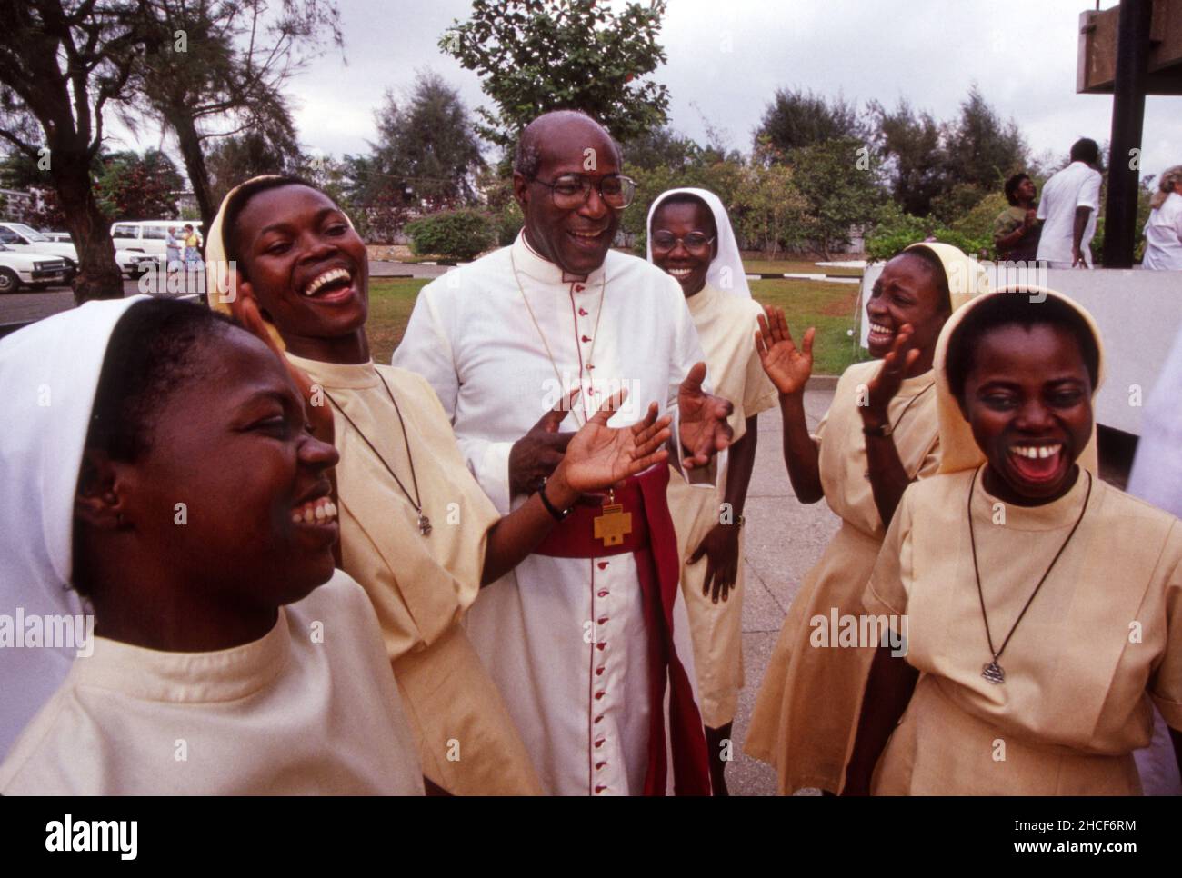 Bischof Moses Anderson, der erste afroamerikanische Bischof der katholischen Erzdiözese Detroit, lacht mit Nonnen auf einer seiner Reisen nach Ghana in Westafrika. Stockfoto