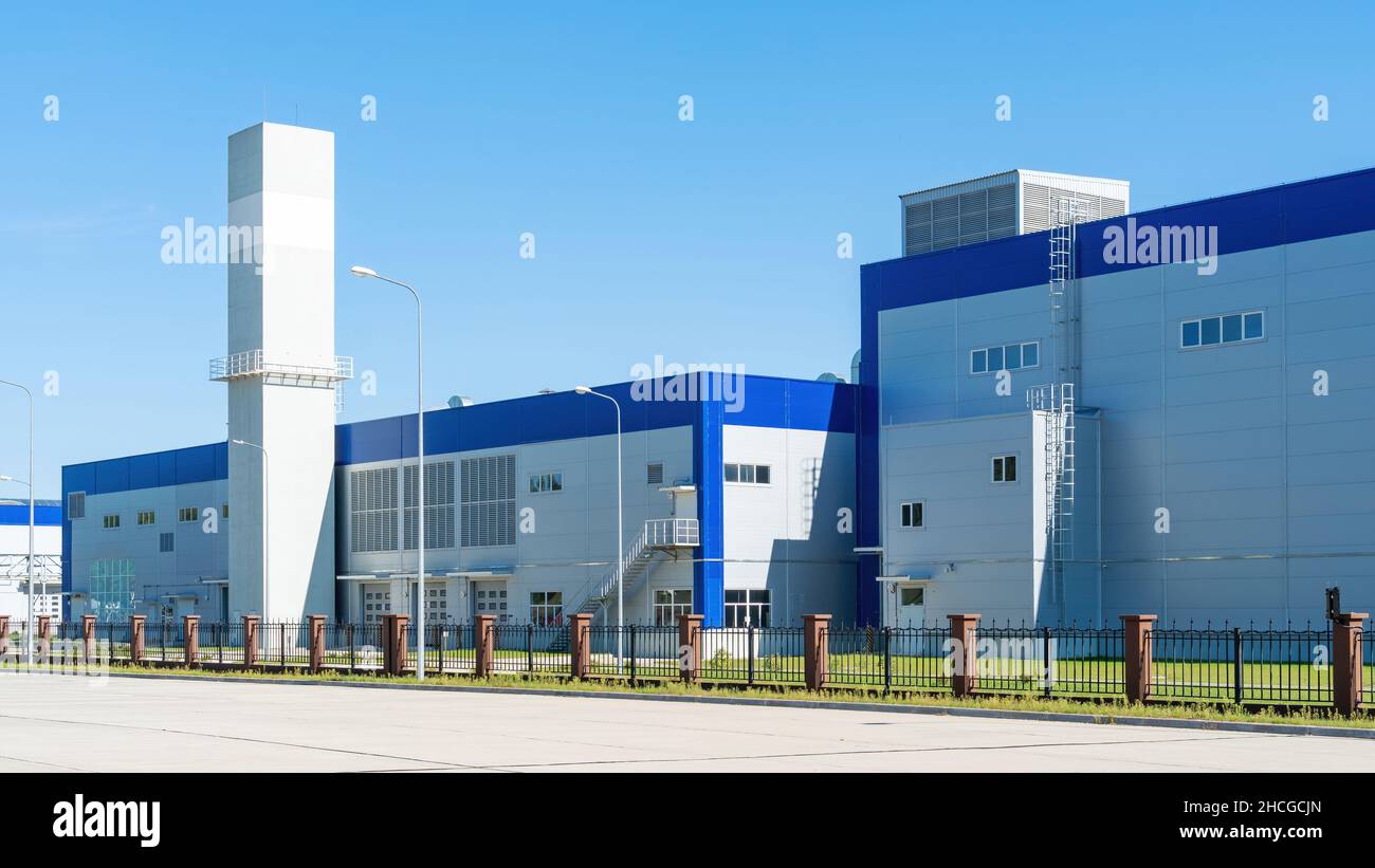 Nahaufnahme des Werksgebäudes von Sandwichpaneelen Außenansicht des Logistikzentrums. Industriegebäude der Ingenieuranlage in sonnigen Tag. Stockfoto