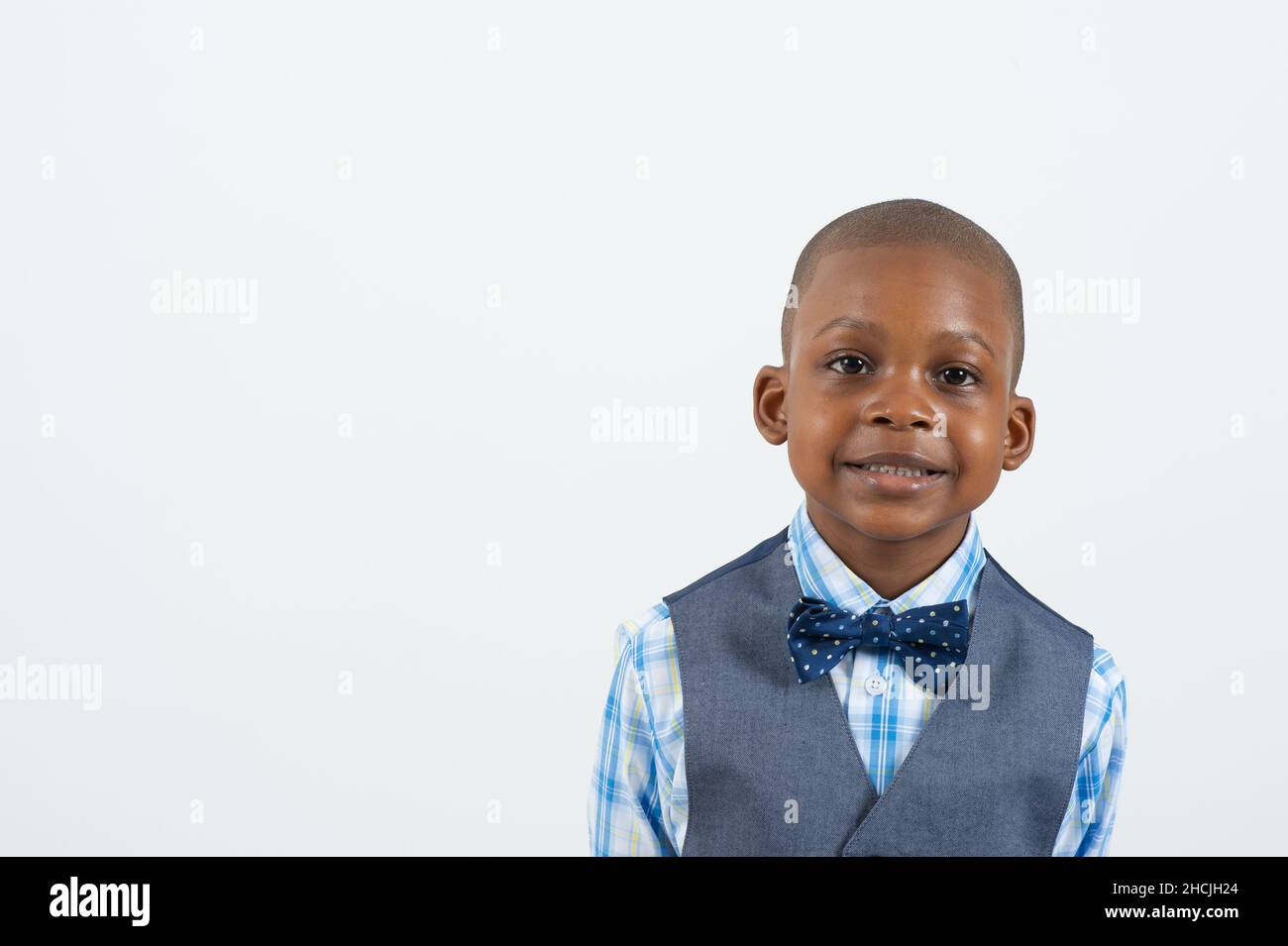 Nahaufnahme Porträt eines 4- oder 5-jährigen Jungen, lächelnd, weißer Hintergrund, Stockfoto