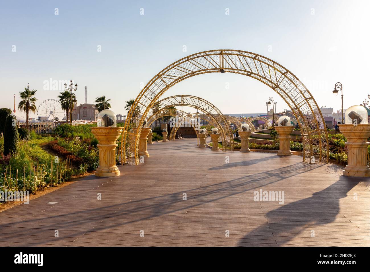 Dubai, VAE, 10.01.21. Vergnügungspark Global Village in Dubai, Holzpromenade mit beleuchteten Bögen, Laternen. Stockfoto
