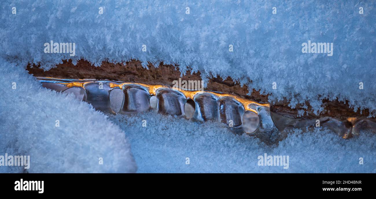 Eiszapfen über dem Wasser im Fluss. Natürliche Landschaft. Winter. Hintergrundbild. Stockfoto