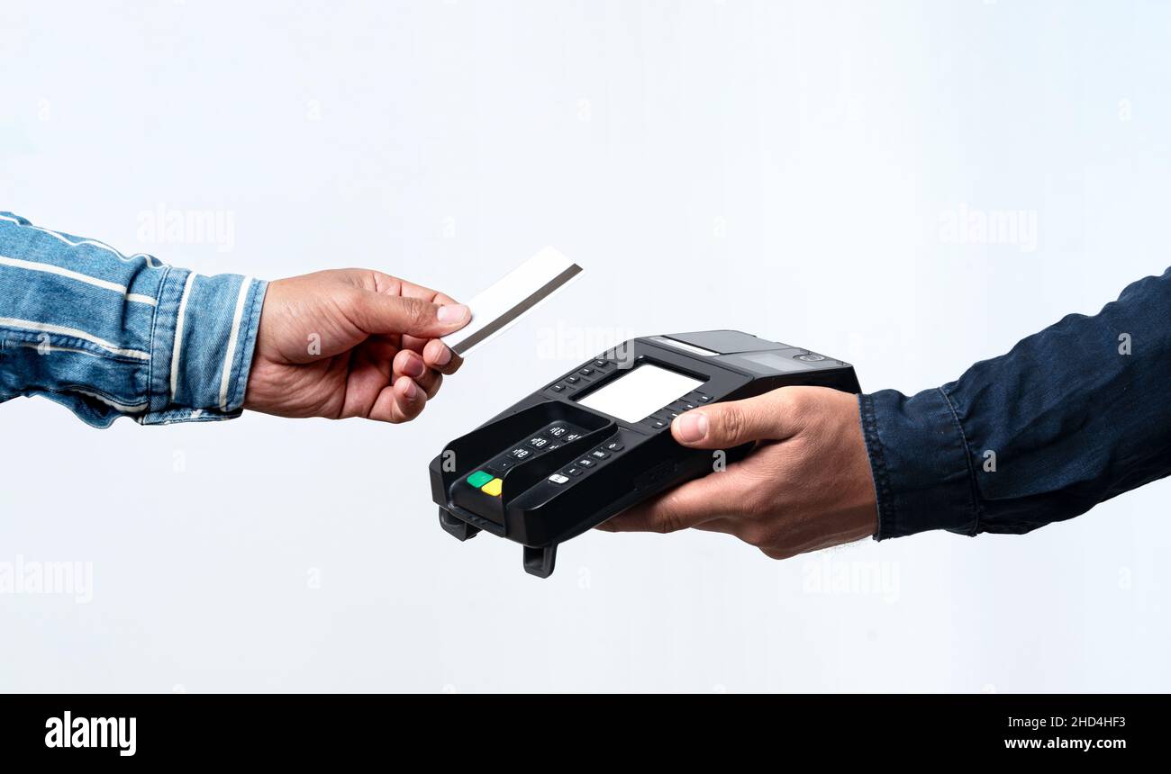 Hände, die POS-Gerät und Kreditkarte auf weißem Hintergrund halten. Kontaktloses und einfaches Zahlungskonzept. Stockfoto