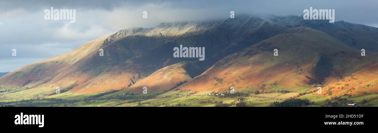 Blencathra Berg im englischen Lake District im Winterlicht mit Schnee auf den Gipfeln. Niedrige Wolke auf den Gipfeln und strahlte Licht auf den Pisten. Stockfoto