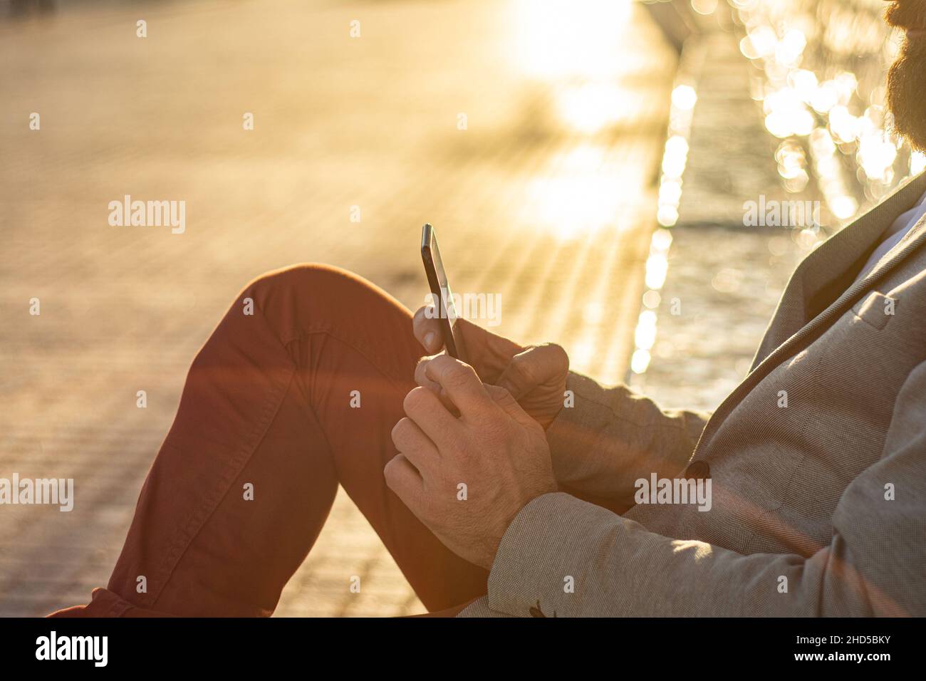 Der Manager hält ein Telefon in den Händen. Porträt eines jungen Unternehmers.Ein neues Geschäftszentrum in der Innenstadt. Stockfoto