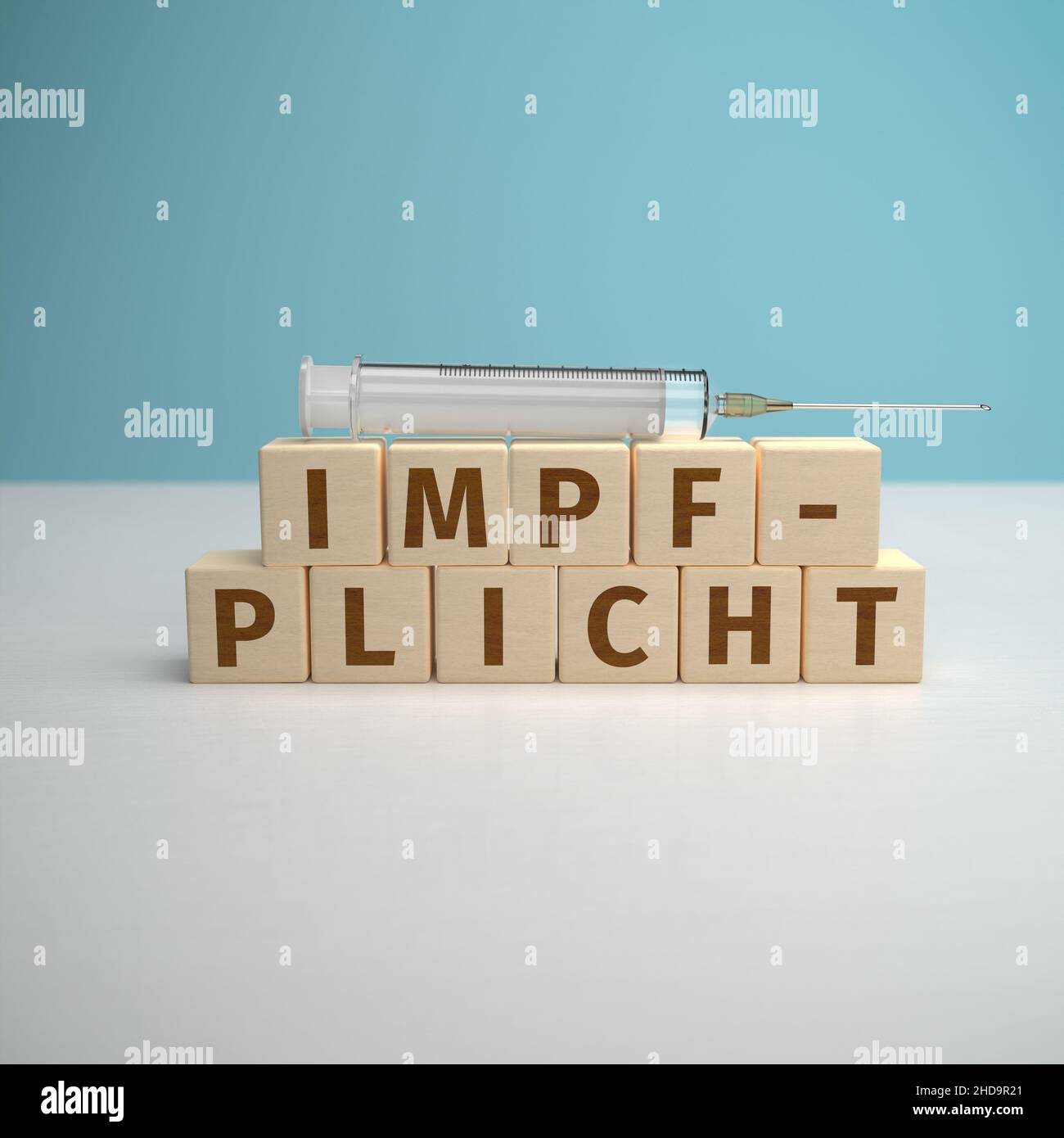 Das deutsche Wort Impfpflicht wurde aus Buchstaben auf Holzwürfeln gebaut. Stockfoto