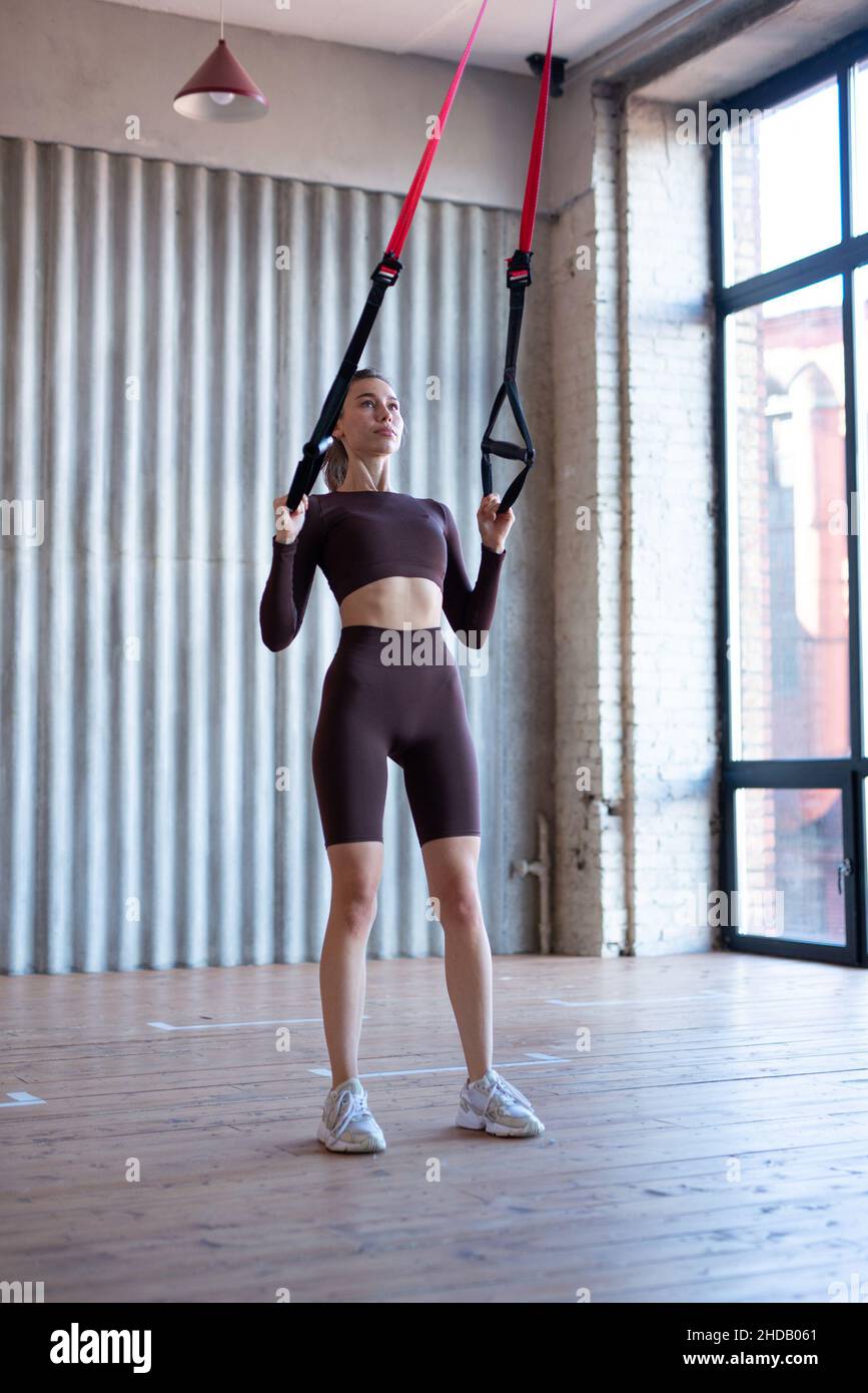 Fit Woman Training mit Fitness trx Straps. Stockfoto