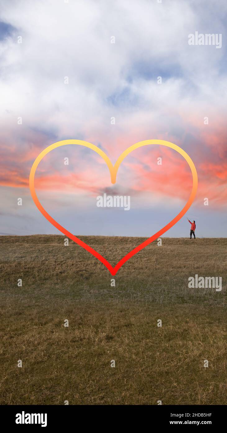 Ein Mann, der ein großes Symbol in Form eines Herzens zeichnet Stockfoto