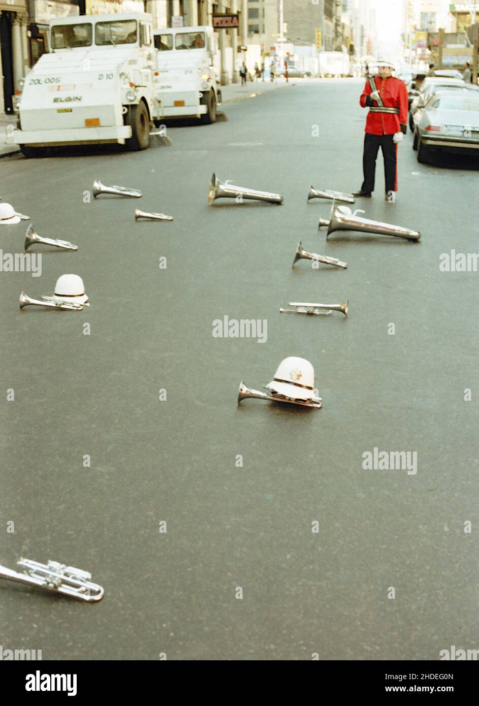 Eine Musikkapelle in Militäruniformen lässt ihre Instrumente und Helme auf der Straße liegen, um während der Columbus Day Parade in den frühen achtziger Jahren in New York, USA, eine Pause einzulegen Stockfoto