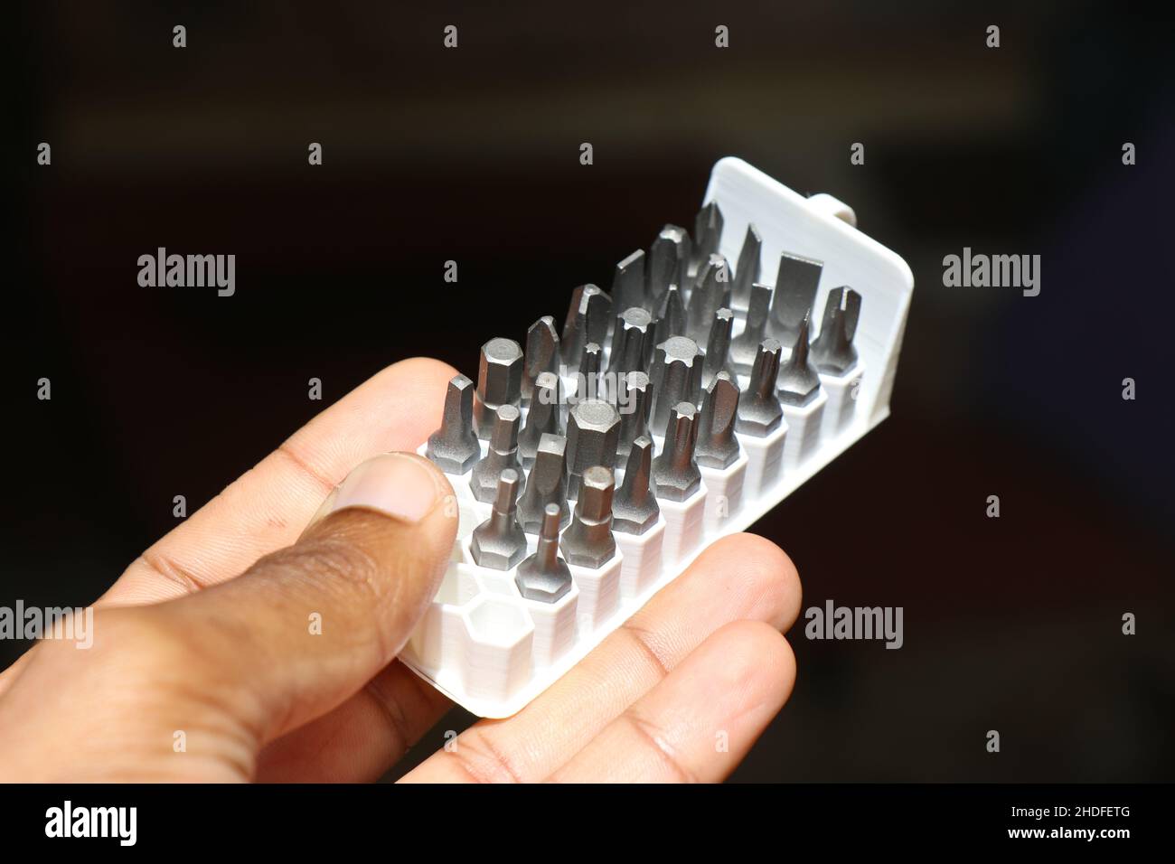 Bithalter aus 3D Drucktechnik mit voll verschraubbaren Bits in der Hand gehalten Stockfoto