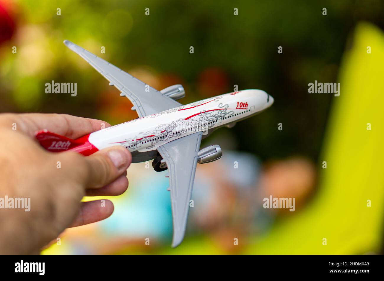 Hand hält ein Spielzeug Modell Passagierflugzeug Stockfoto