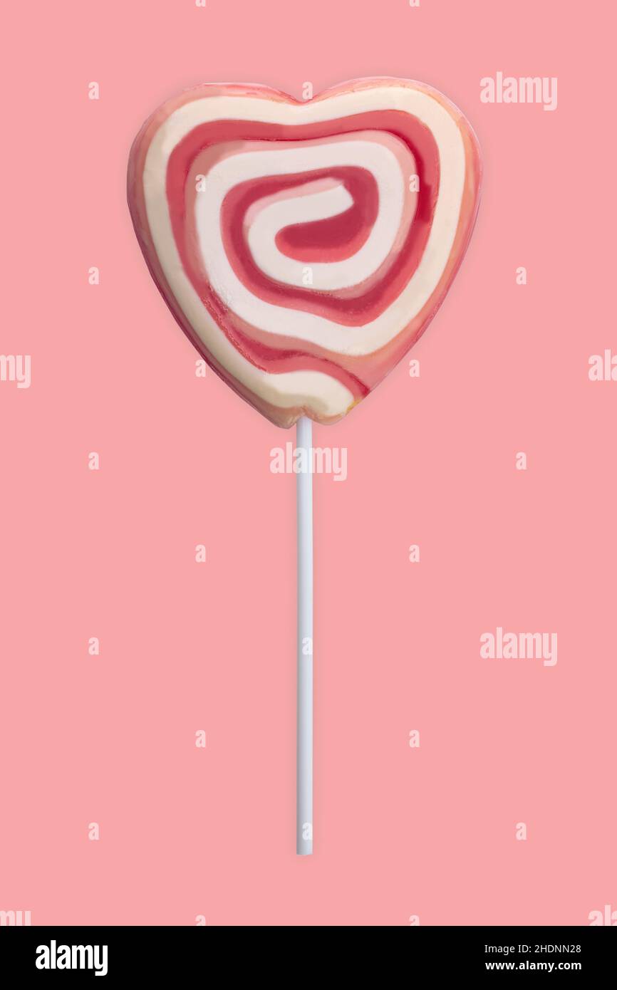 Rosa und weiße Wirbel Lollipop isoliert auf rosa Hintergrund Stockfoto