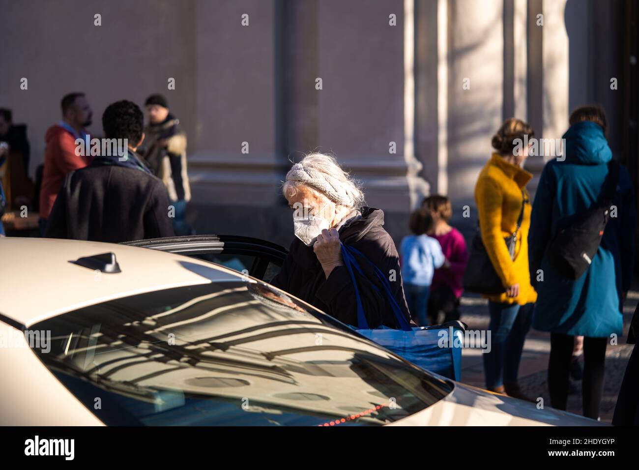 Die alte Dame steigt in München in ein Taxi Stockfoto