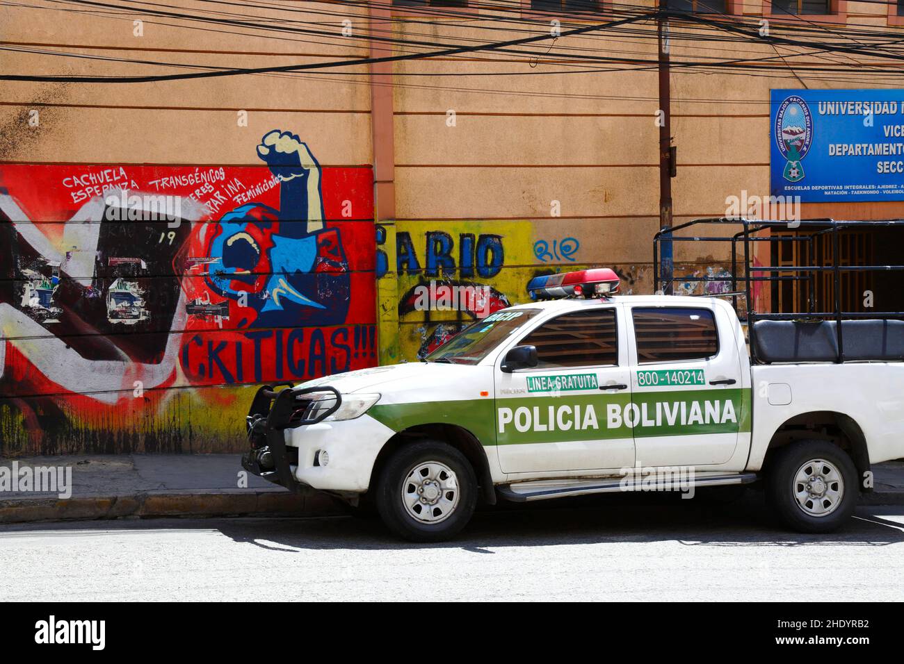 Die Abholung des bolivianischen Polizisten Toyota Hilux parkte neben dem Protestgemälde der Kommunistischen Partei vor der MSA-Universität, La Paz, Bolivien Stockfoto