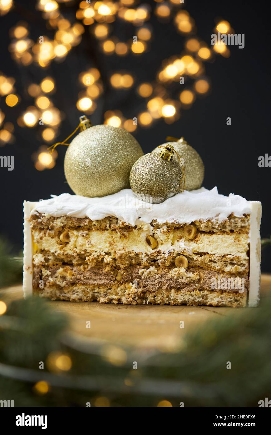 Ein Stück Kuchen auf einem Hintergrund von weihnachtslichtern. Stockfoto